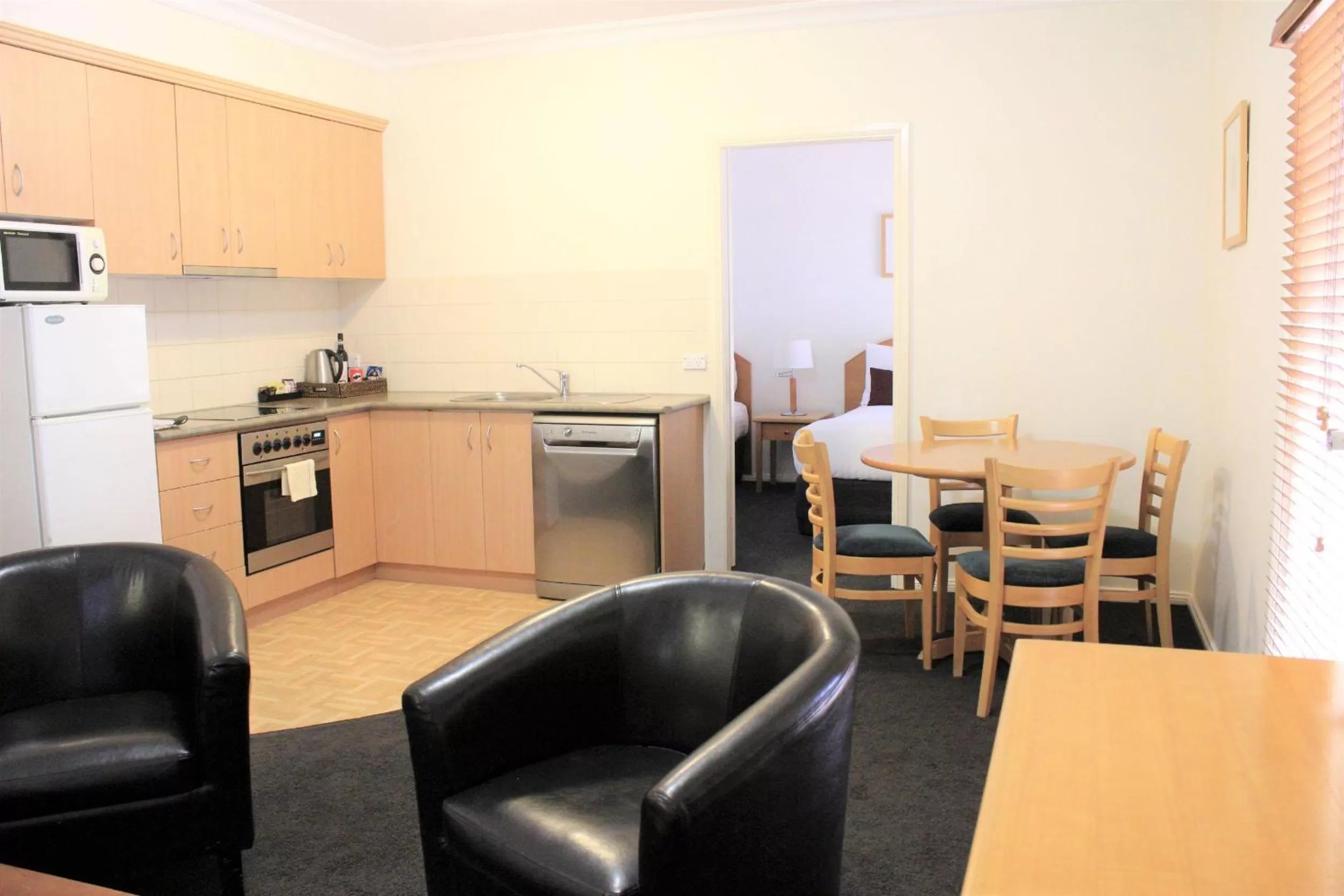 Kitchen or kitchenette in Carlyle Suites & Apartments