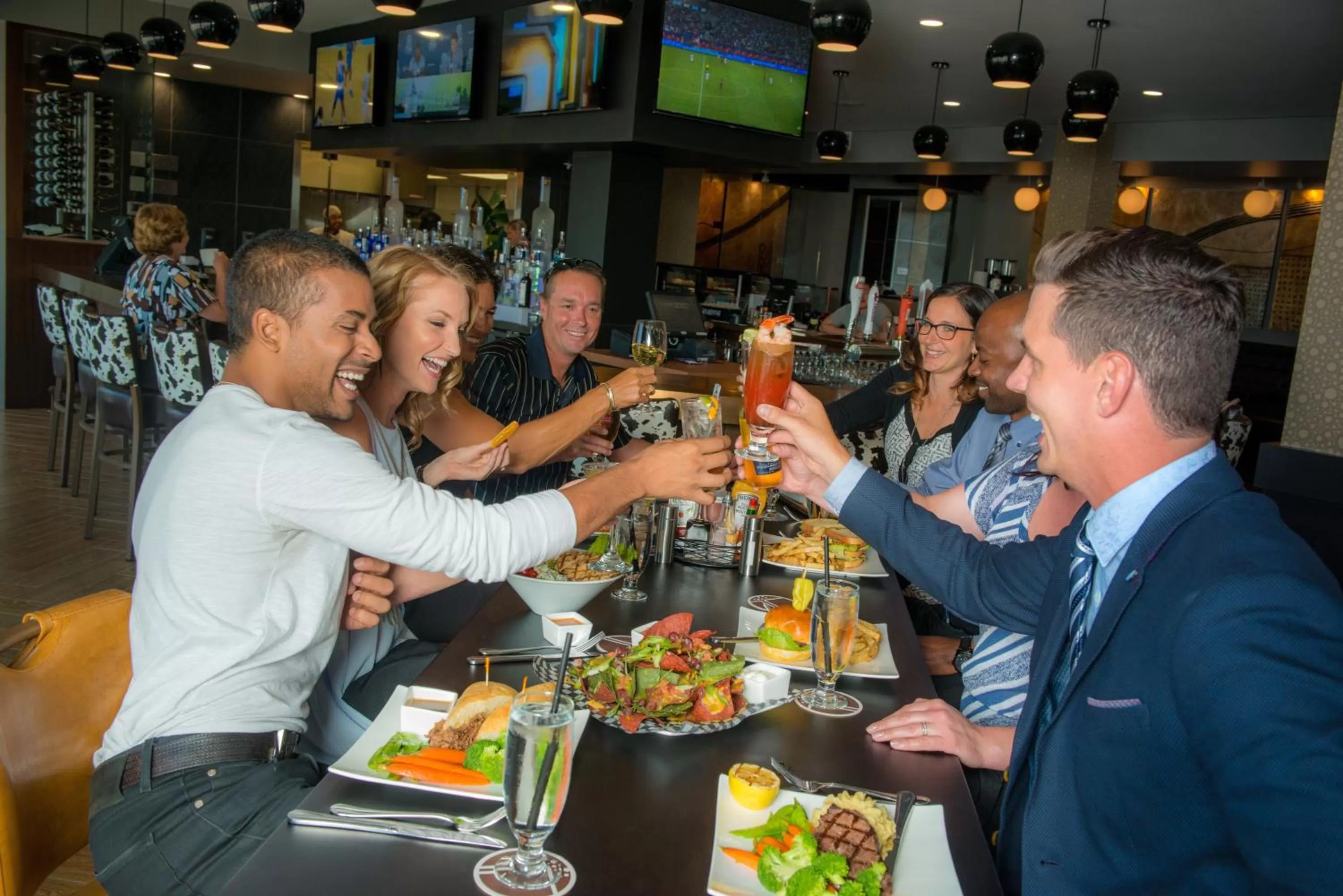 group of guests in Applause Hotel Calgary Airport by CLIQUE