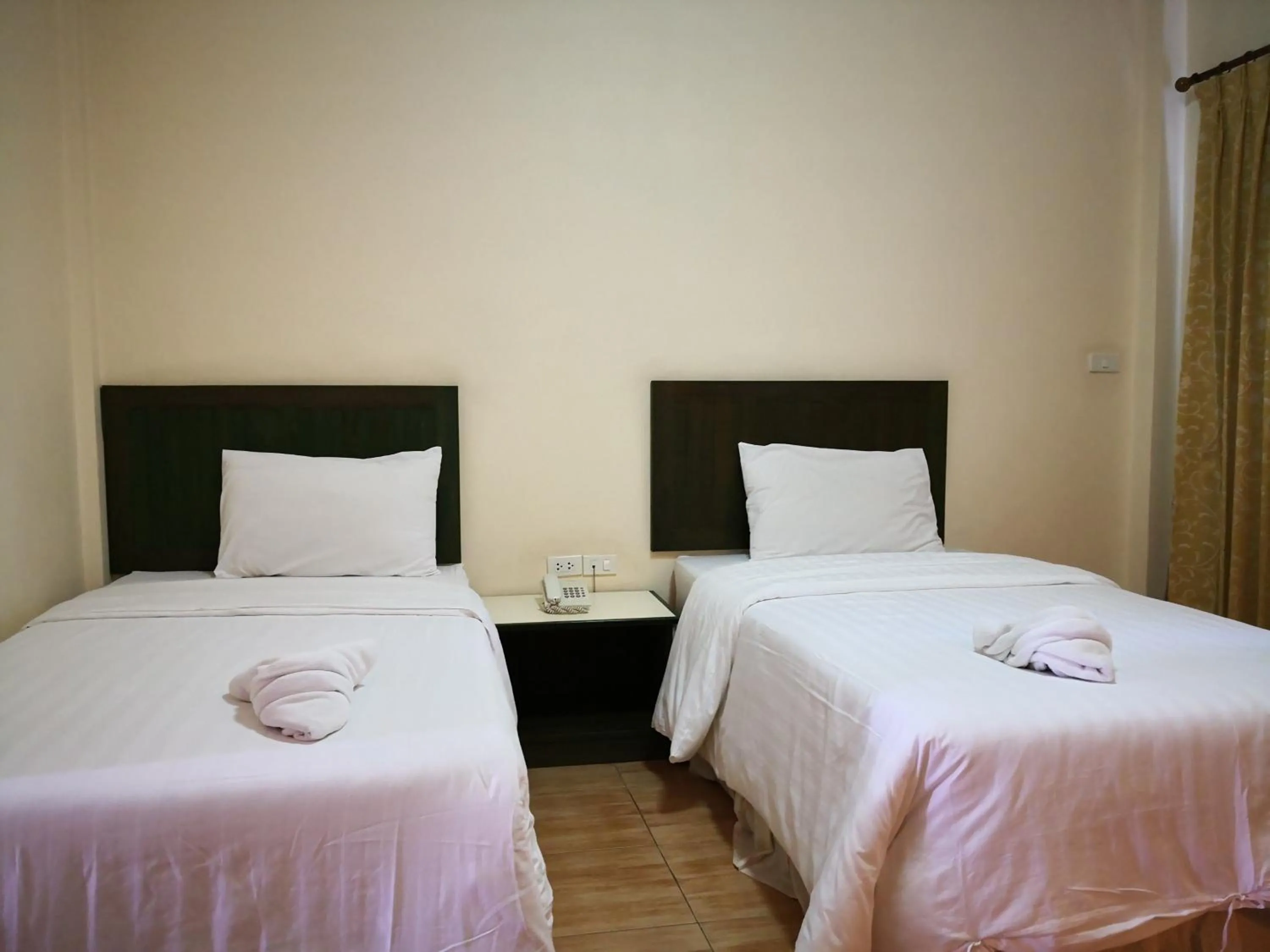 Bed in Baan Suksiri Hotel