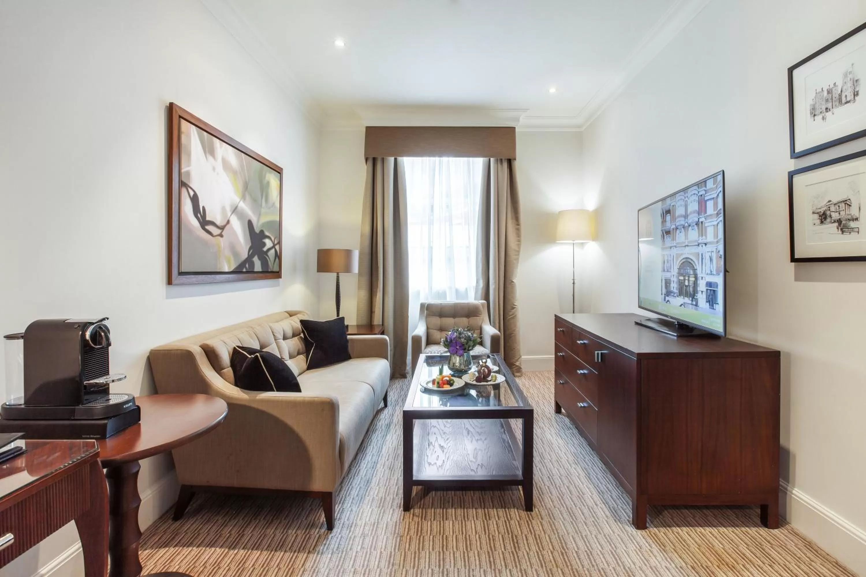 Communal lounge/ TV room in St. James' Court, A Taj Hotel, London