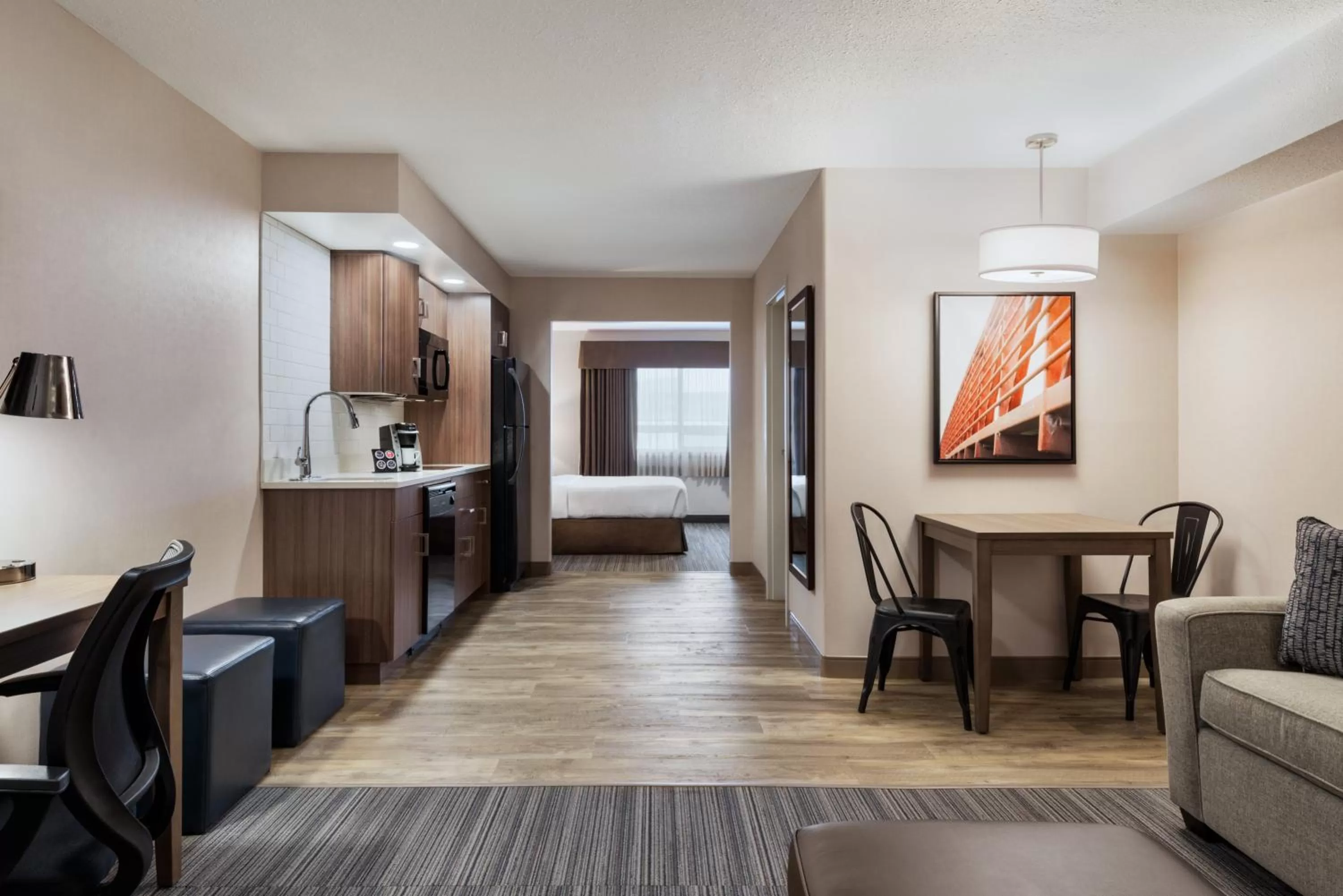 Living room, Bed in Ramada by Wyndham Airdrie Hotel & Suites