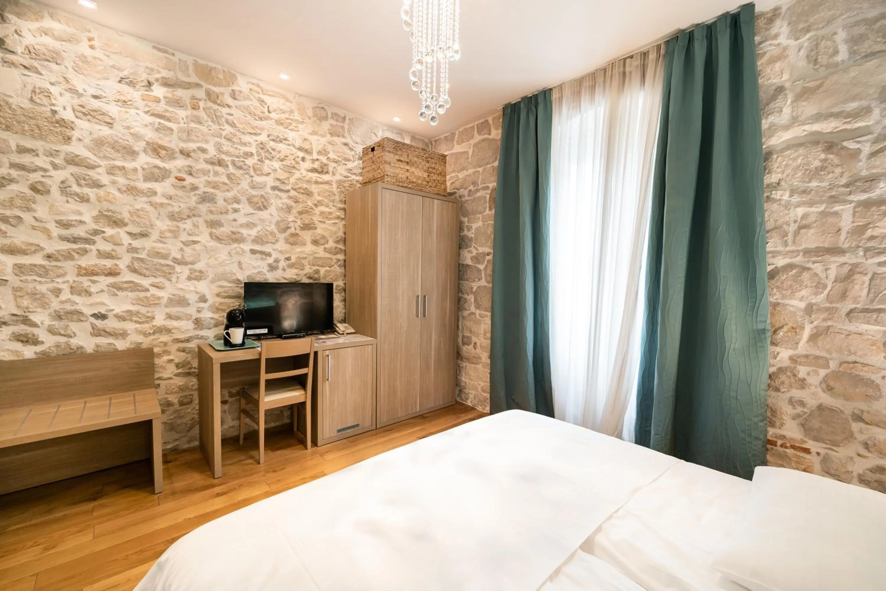 Bed in Tifani Luxury Rooms