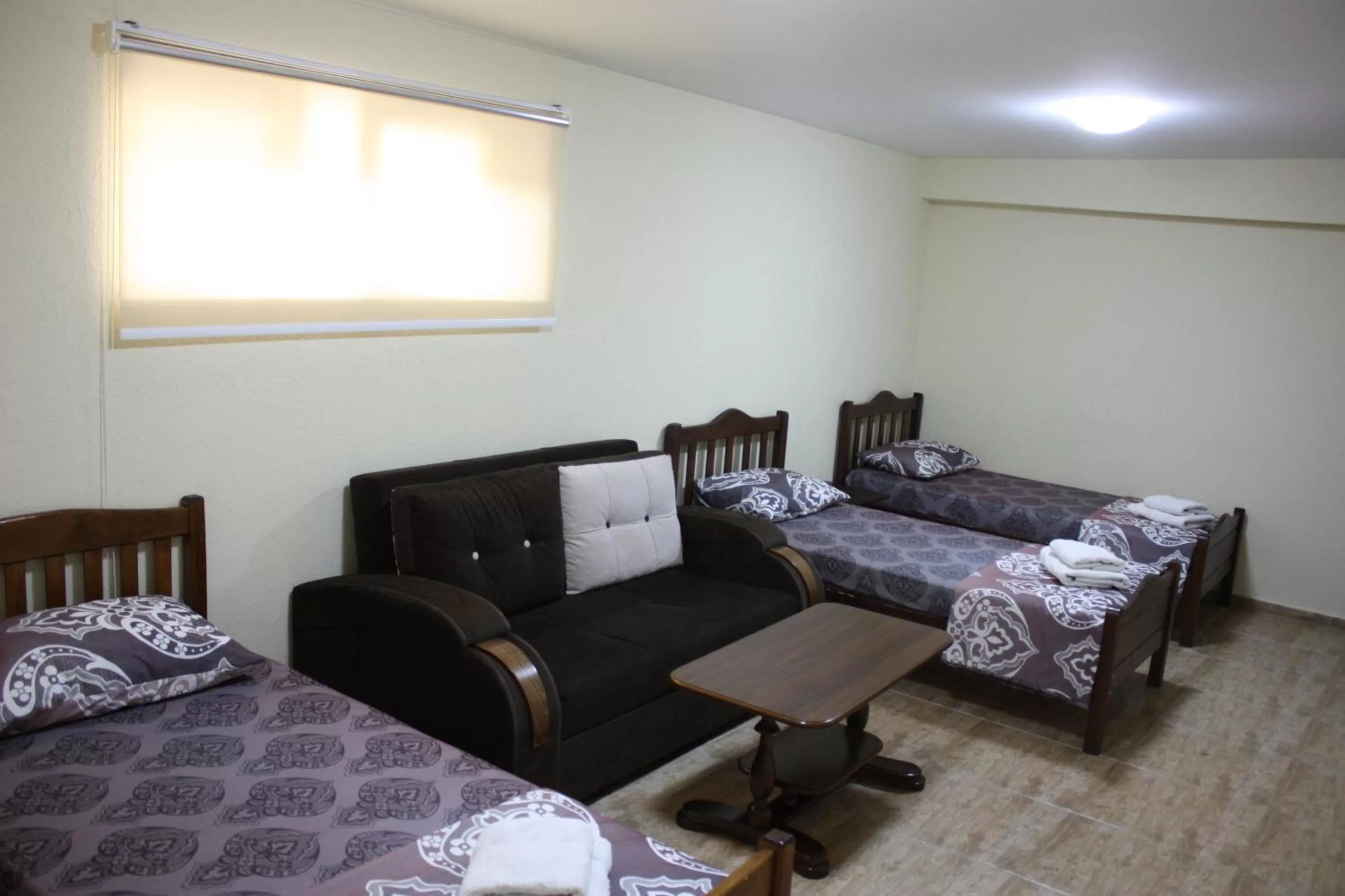 Living room, Bed in Paradise Hotel