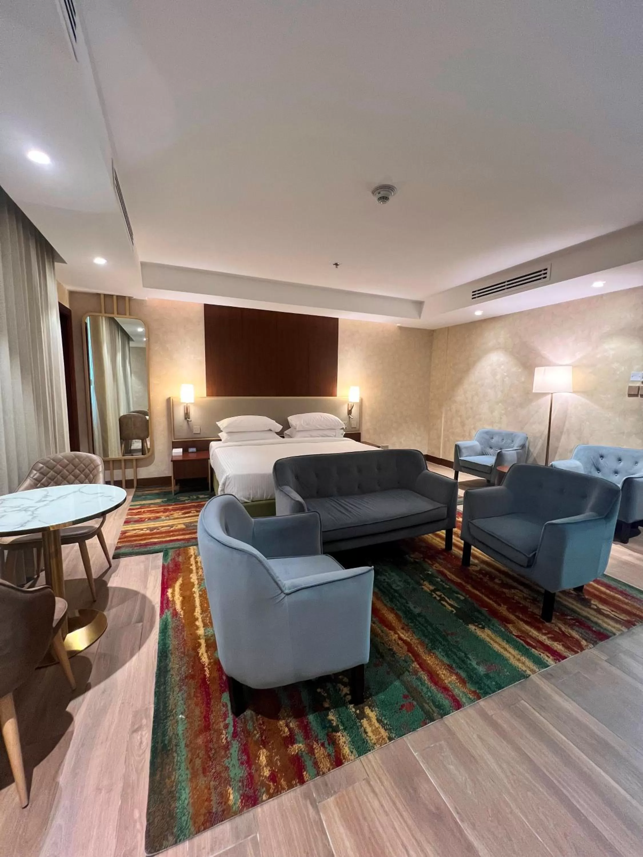 Seating area, Bed in City Seasons Suites