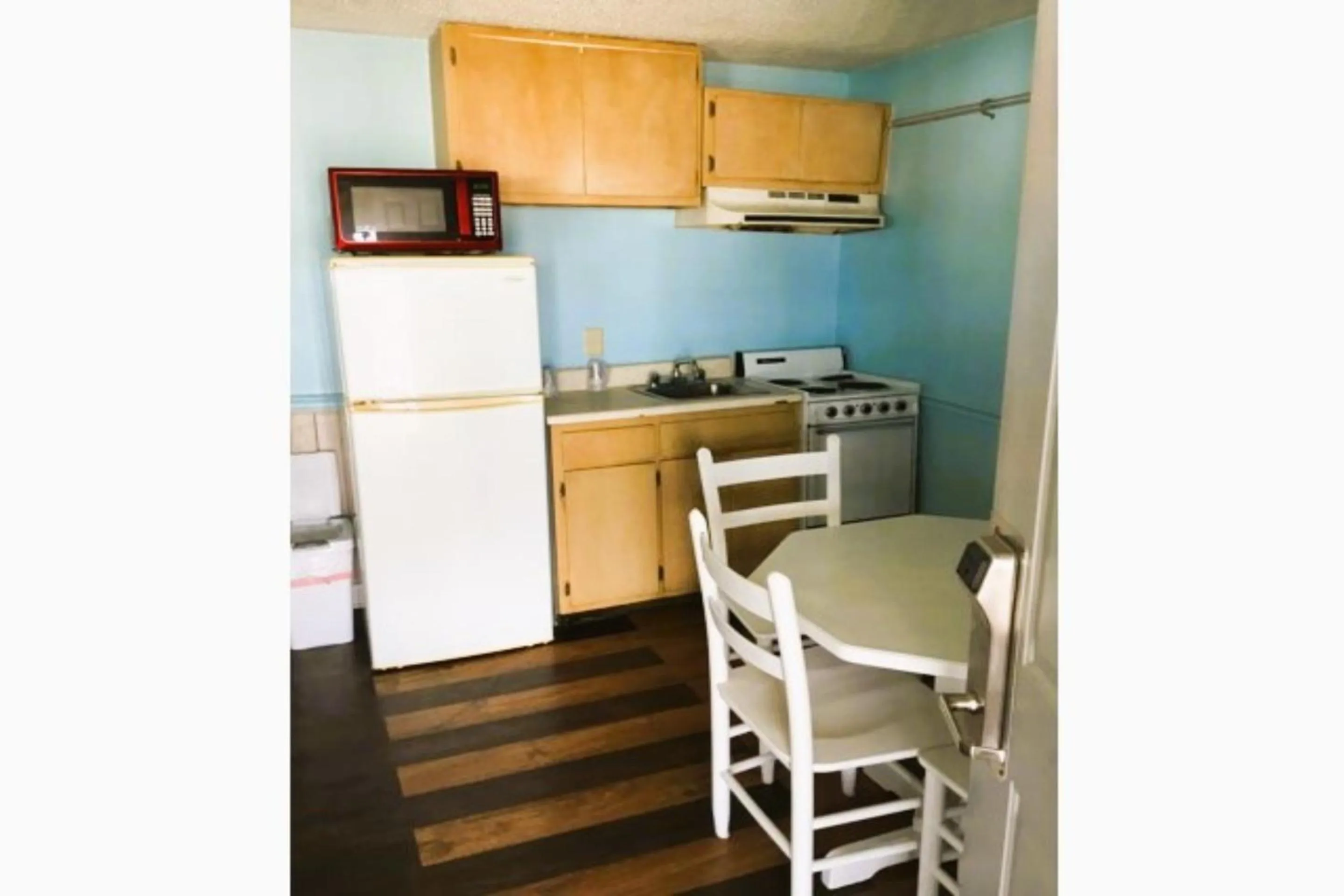 Kitchen or kitchenette in Crepe Myrtle by OYO