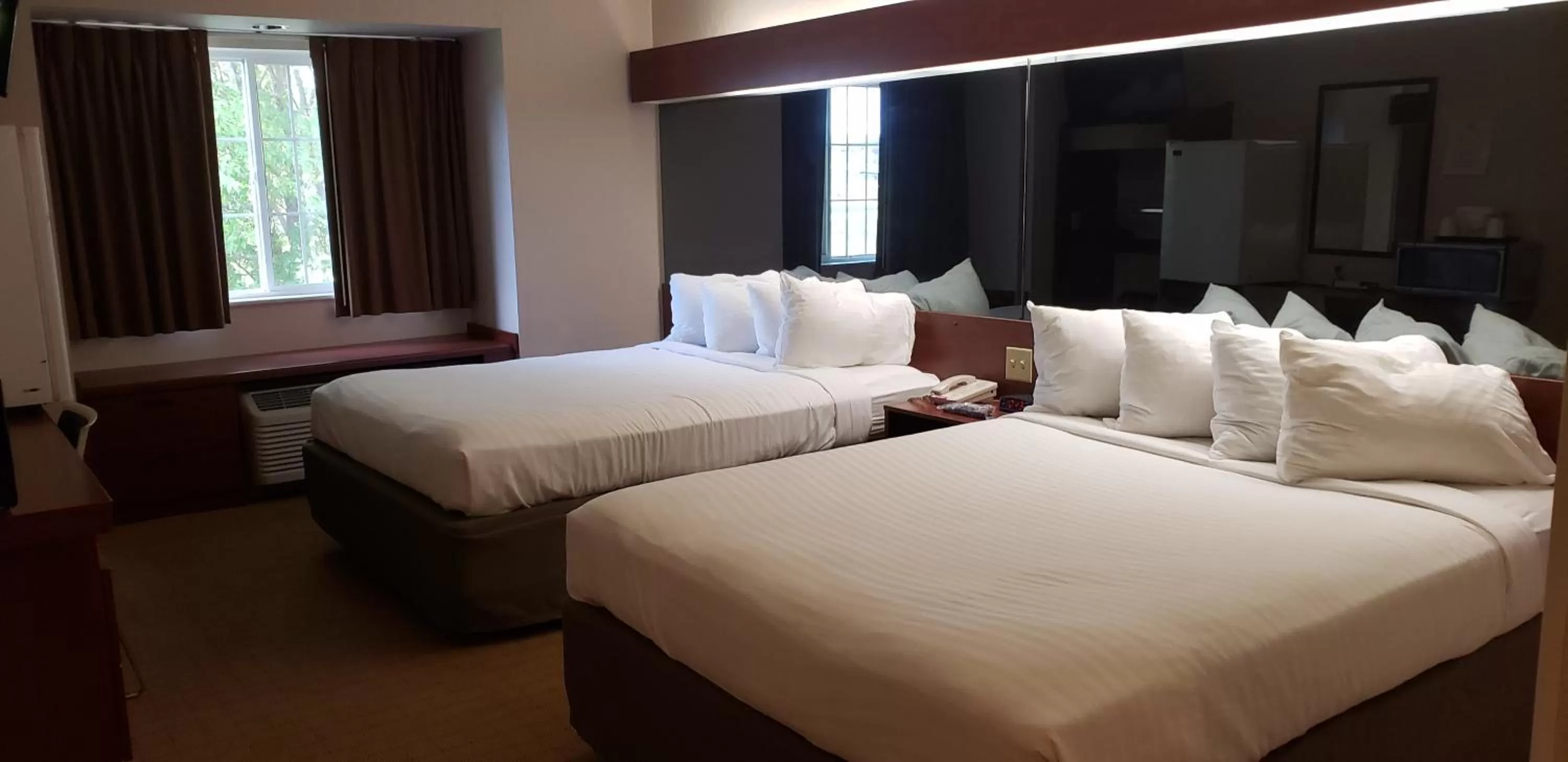 Bed in Microtel Inn & Suites by Wyndham Wellsville