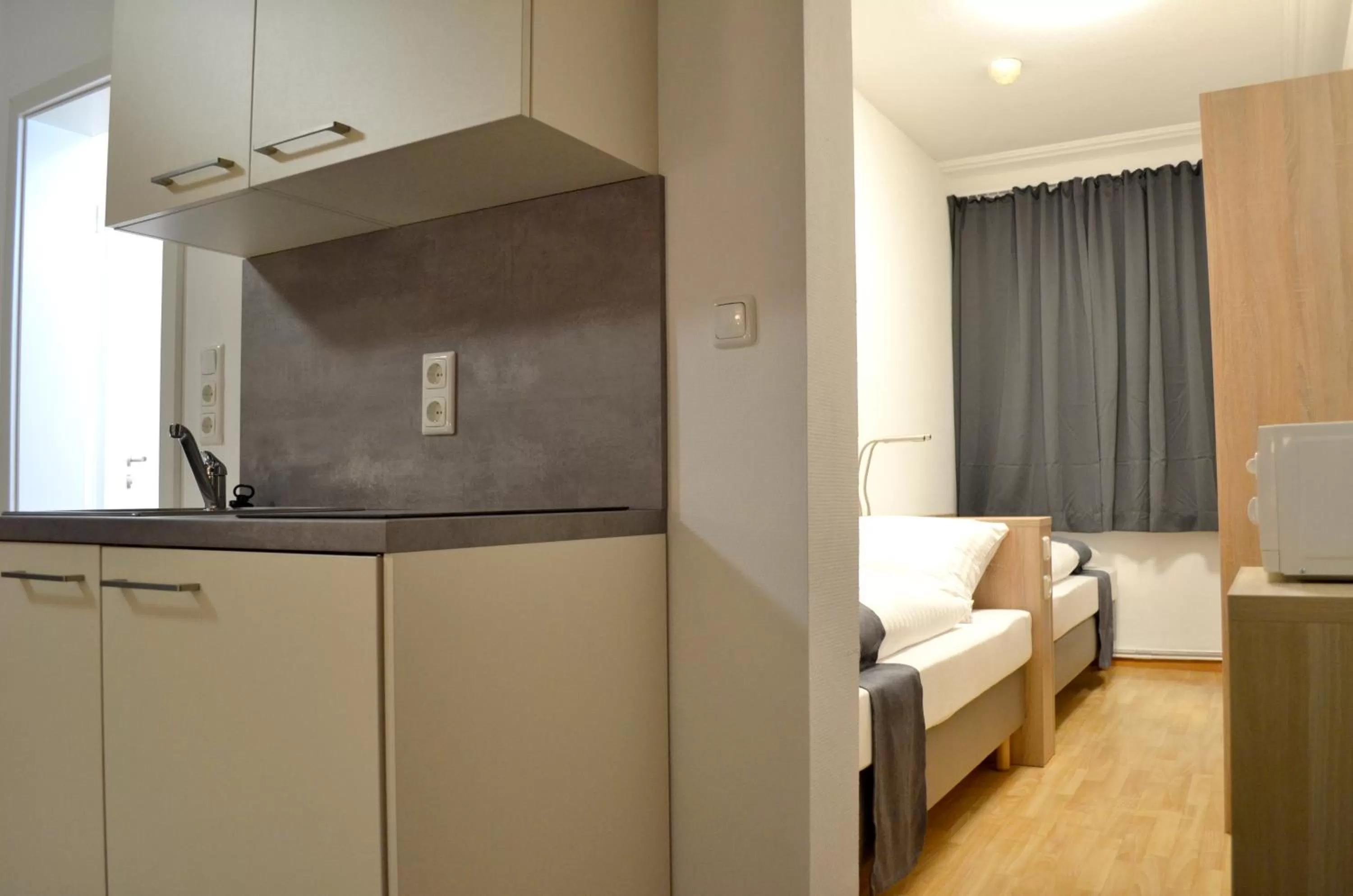 Kitchen or kitchenette, Bed in Hana Aparthotel