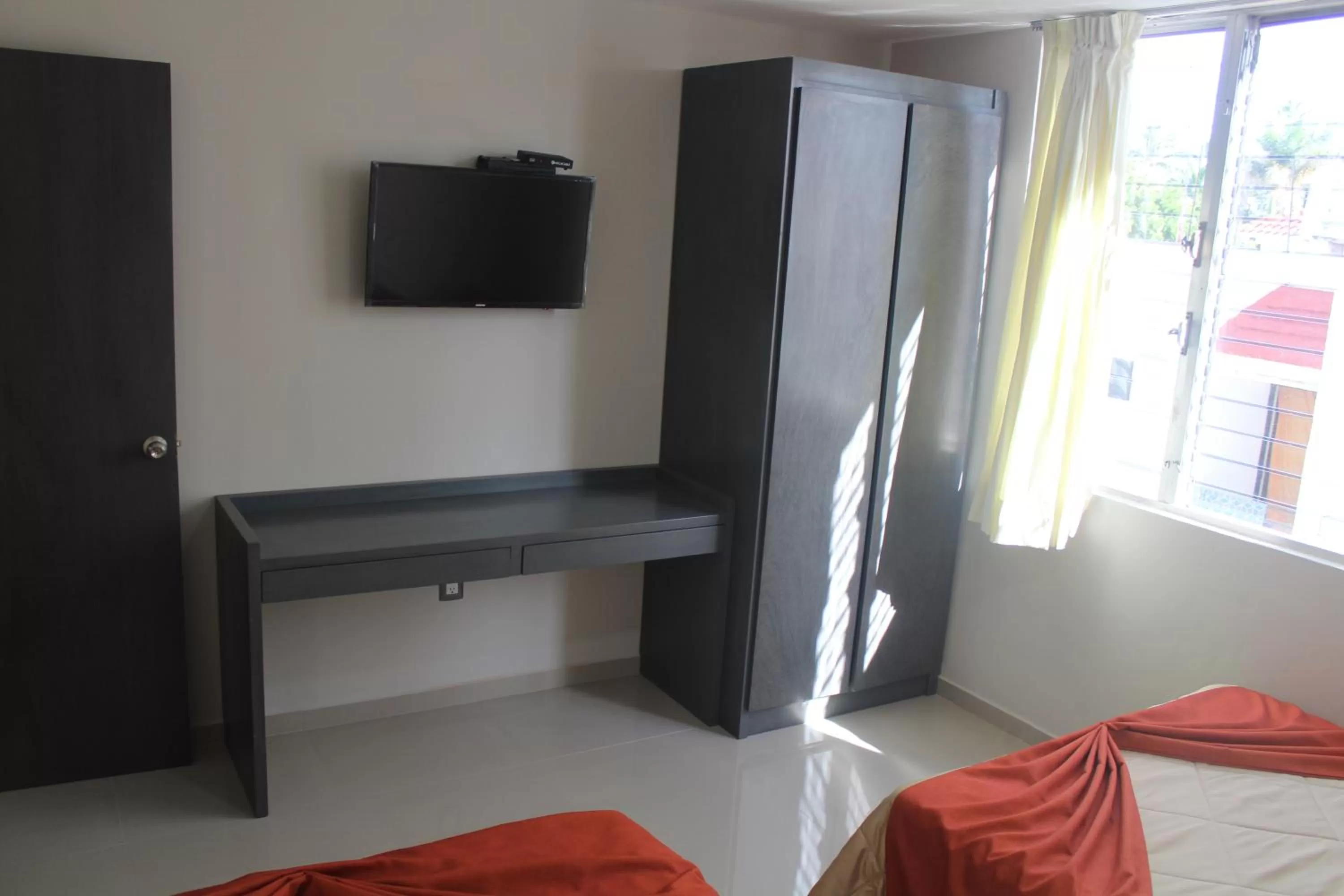 Bedroom, TV/Entertainment Center in Suites San Luis