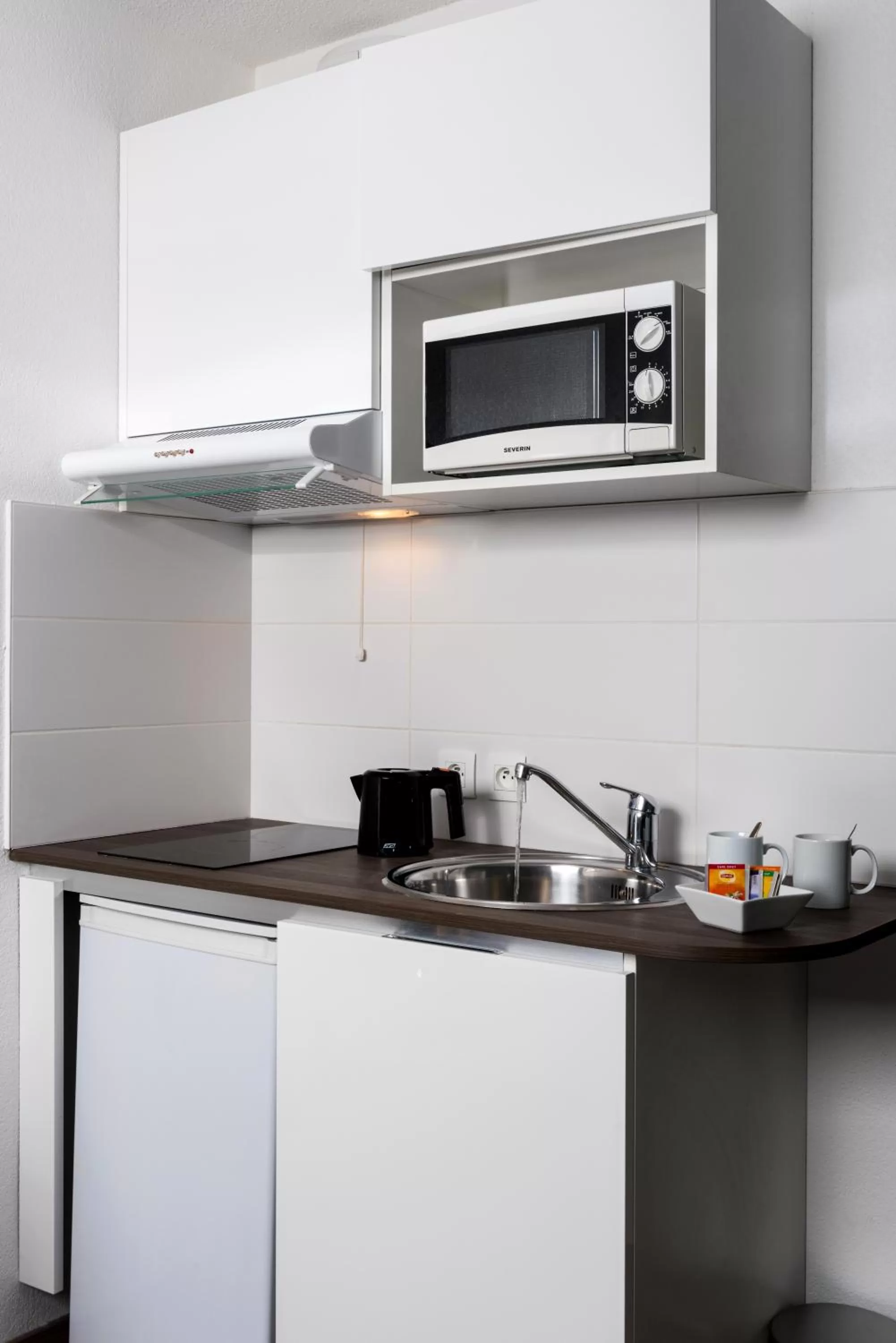 Kitchen or kitchenette in Ténéo Apparthôtel Bordeaux Maritime - Cité du vin