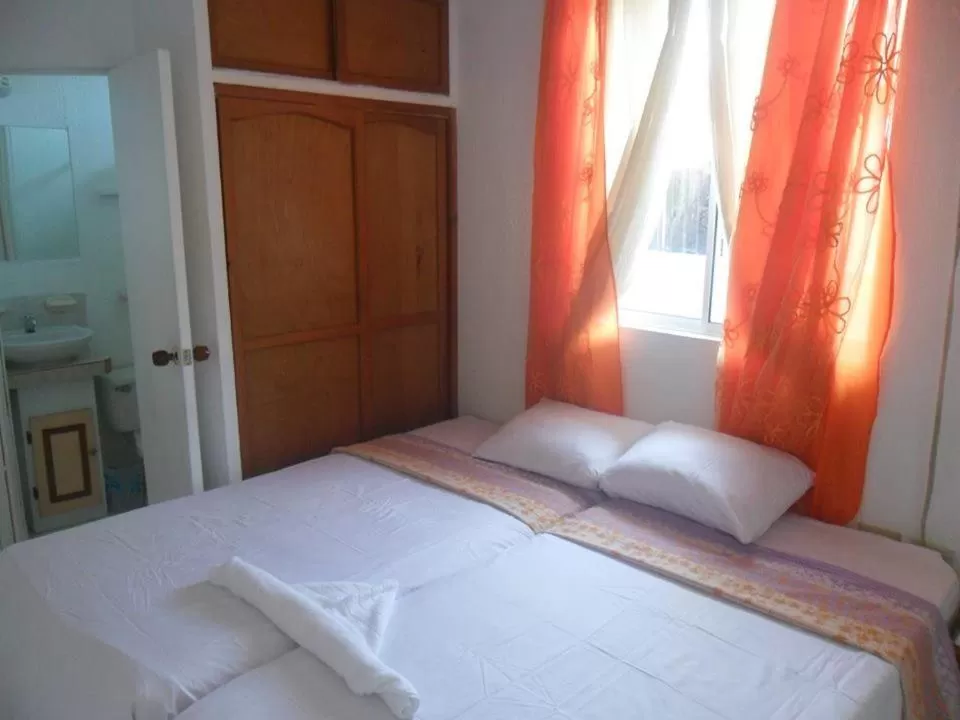 Bed in Posada Caribbean Refuge