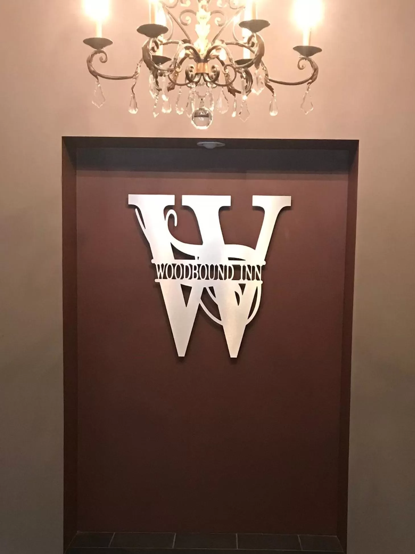 Property logo or sign in Woodbound Inn