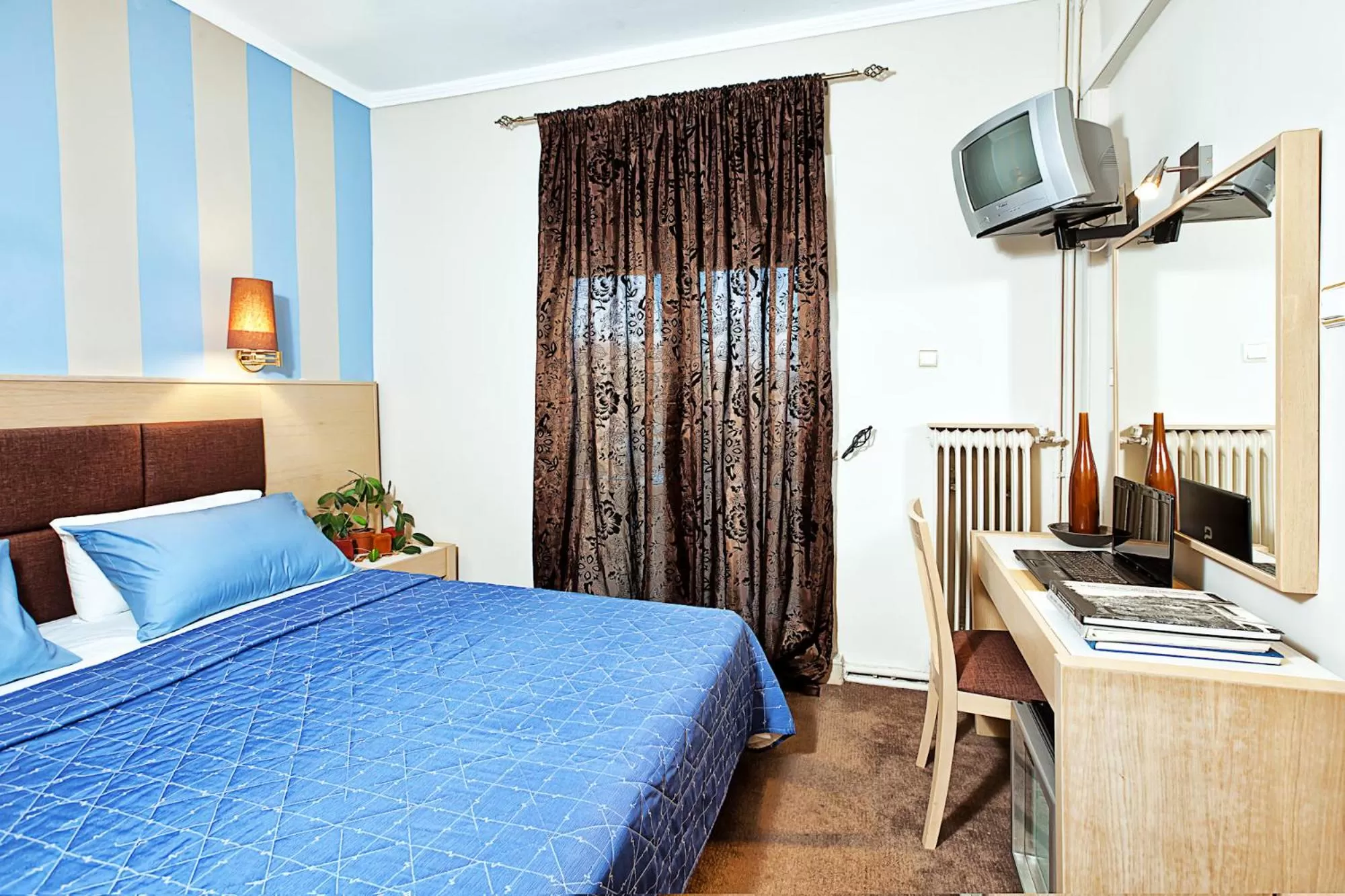 Property building, Bed in Anastassiou Hotel - Bike and motorcycle friendly hotel