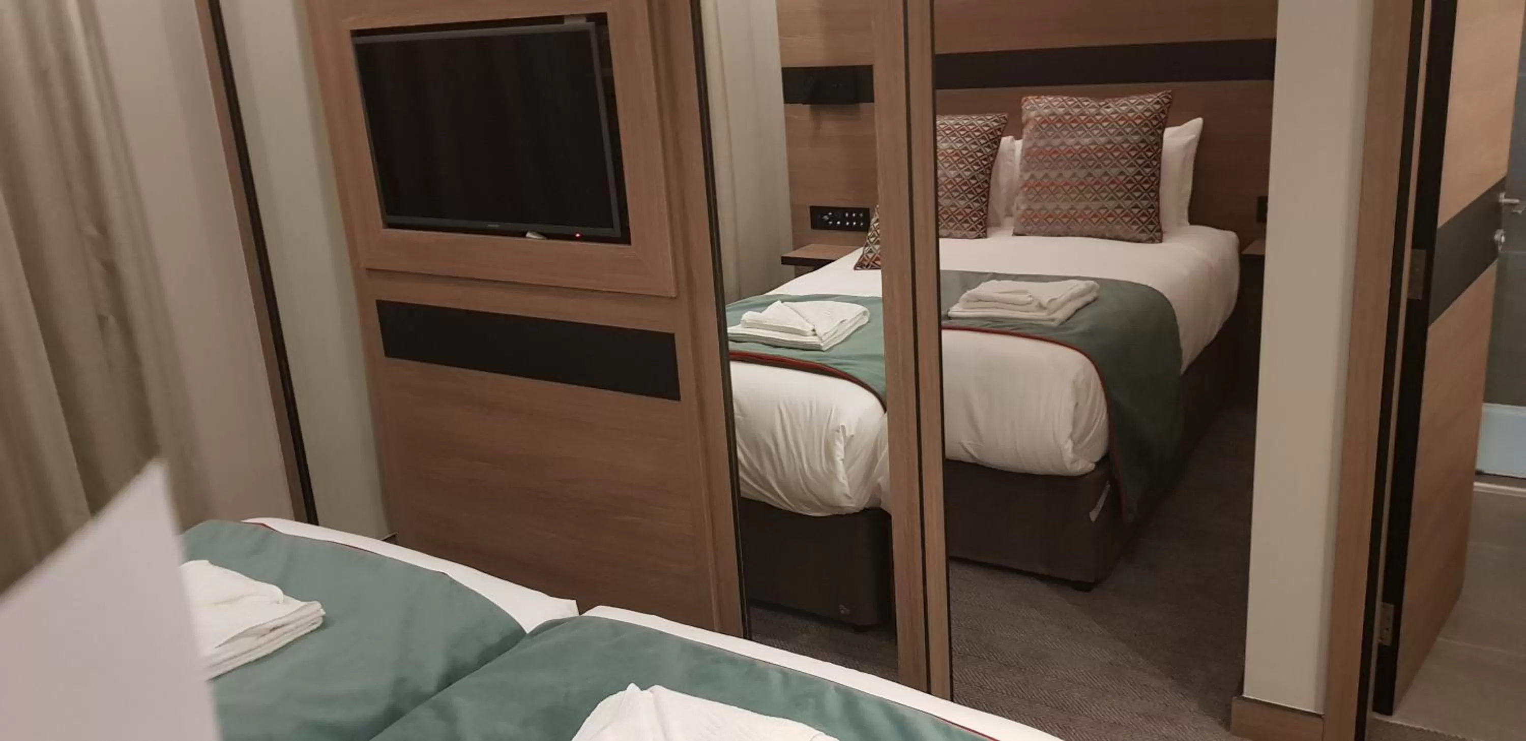 Bed in Merit Kensington Hotel