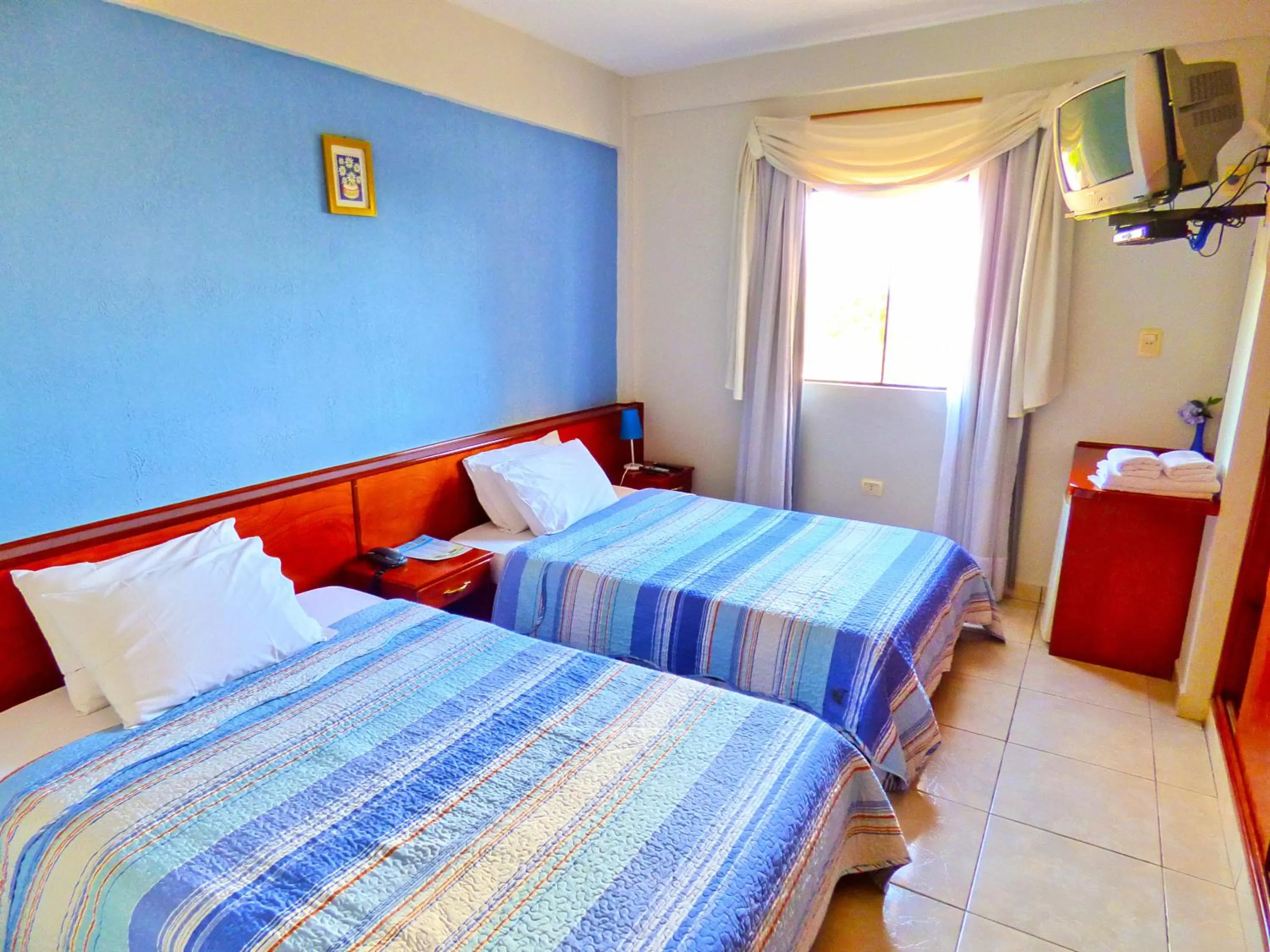 Bed in De La Costa Hotel