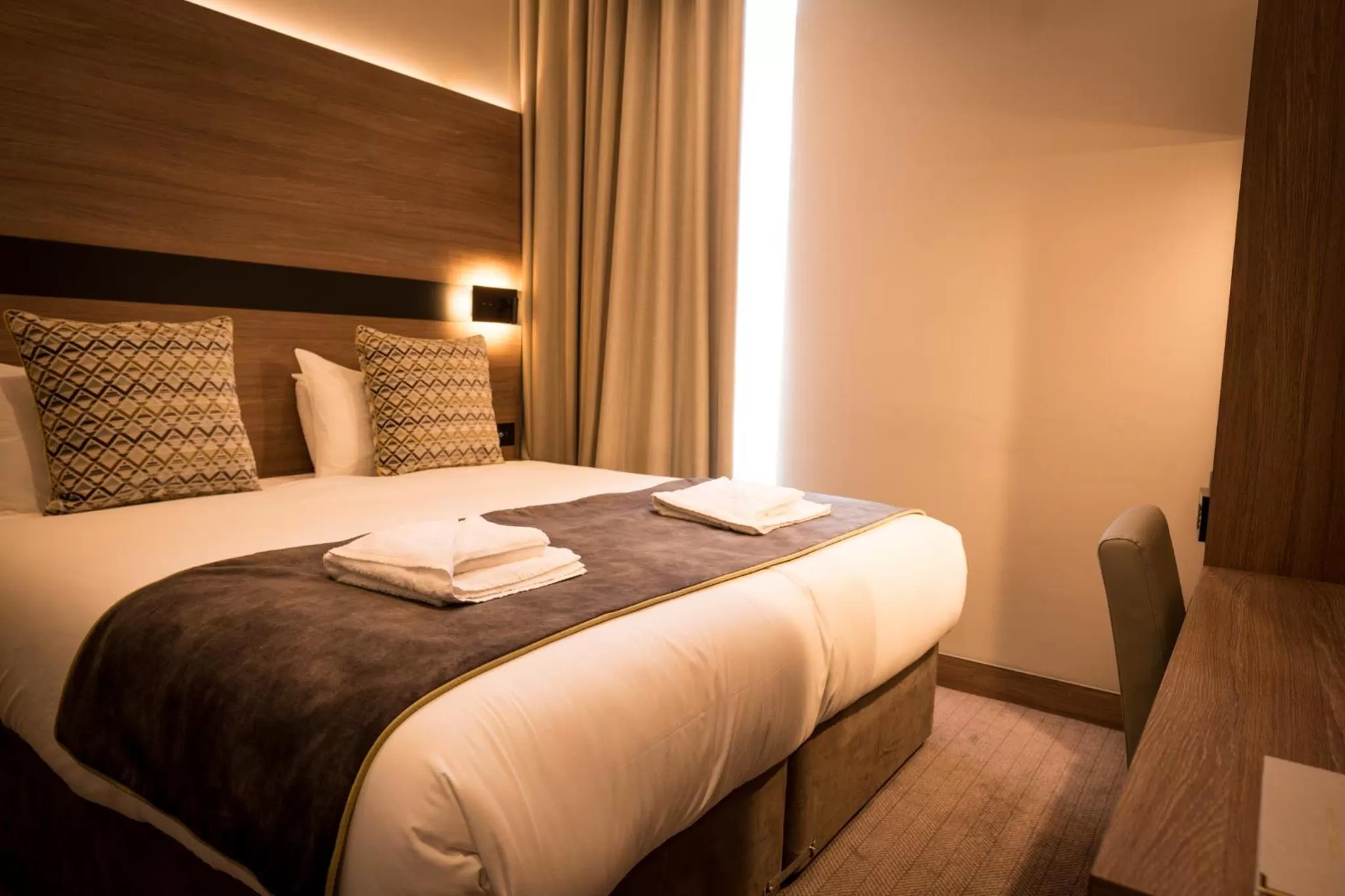 Bed in Merit Kensington Hotel