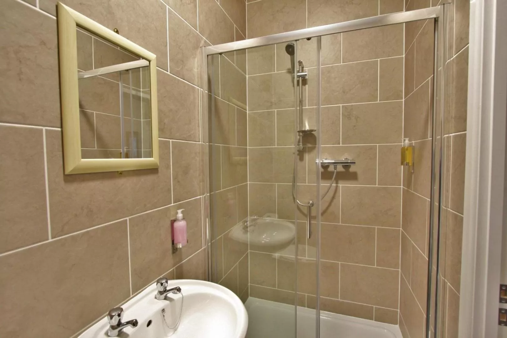 Shower in New County Hotel & Serviced Apartments by RoomsBooked