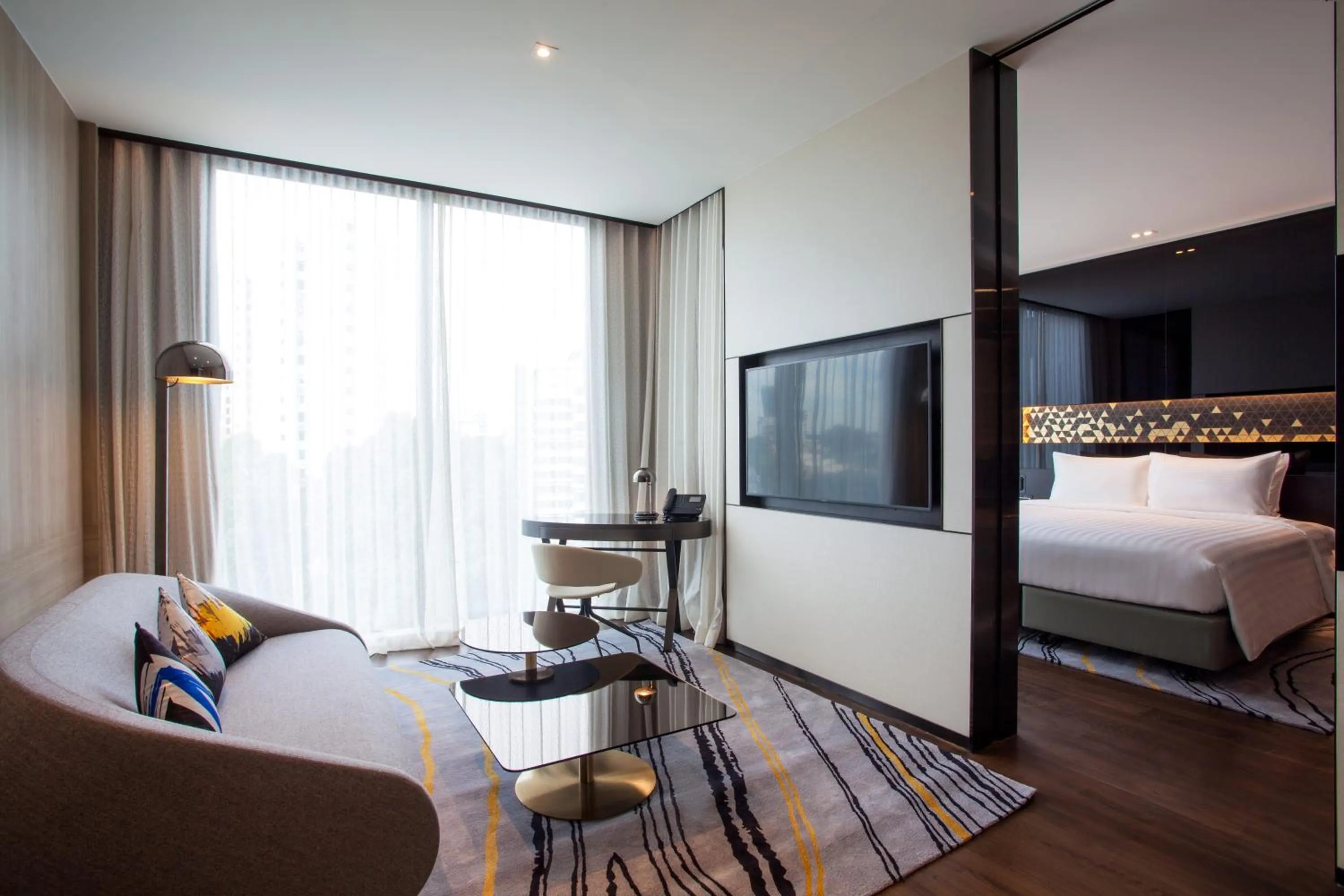 Seating area, Bed in Novotel Singapore On Stevens