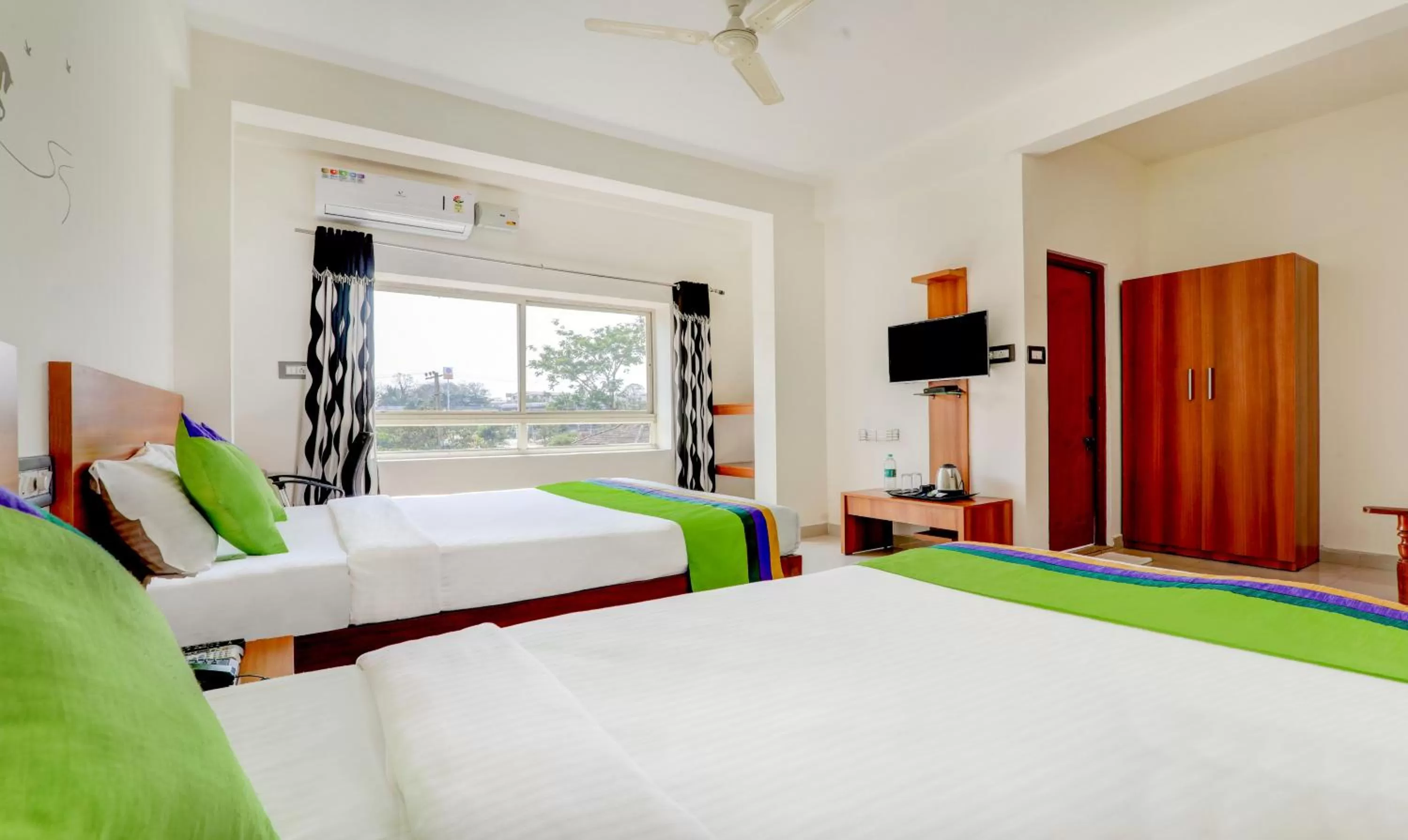 Bedroom, Bed in Treebo Atithi Comforts, 1 Km From Nisargadhama Forest