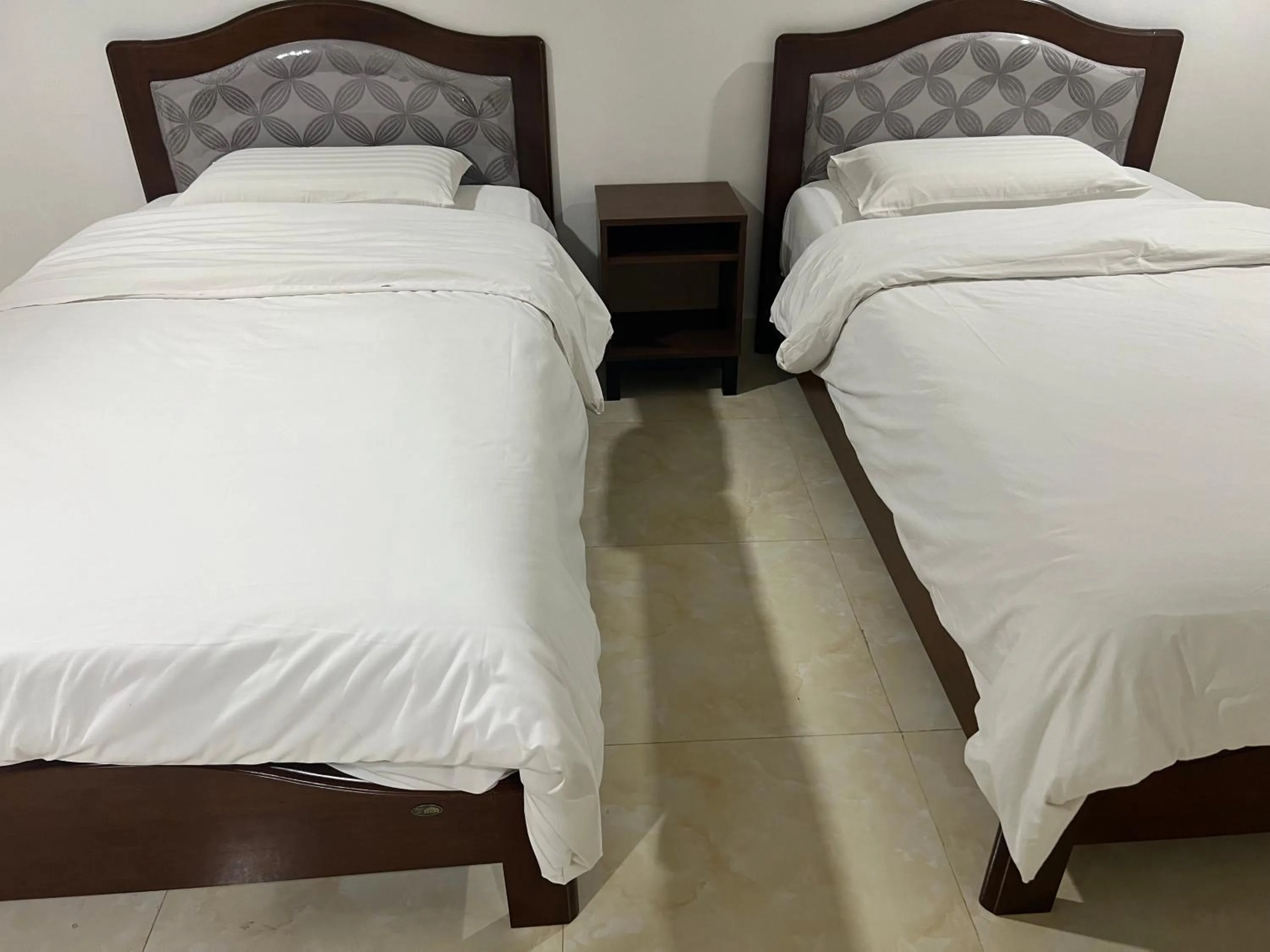 Bed in Mall Suites Hotel