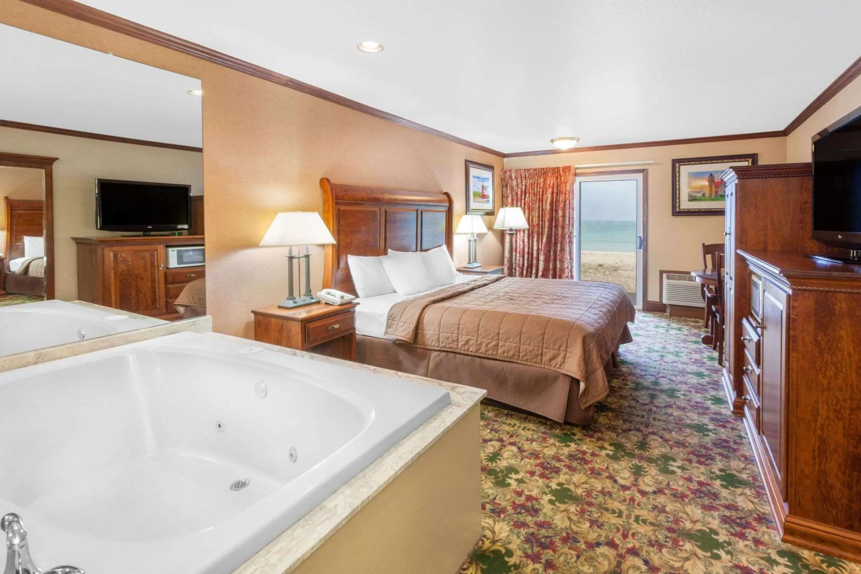 Photo of the whole room, Bed in Ramada by Wyndham Mackinaw City Waterfront