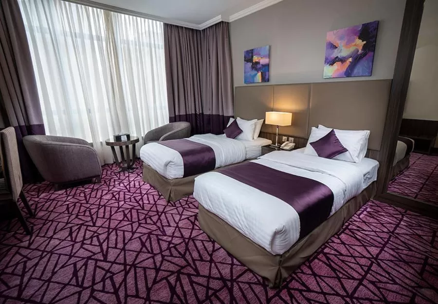 Bedroom in Aquila Al Hamra Hotel