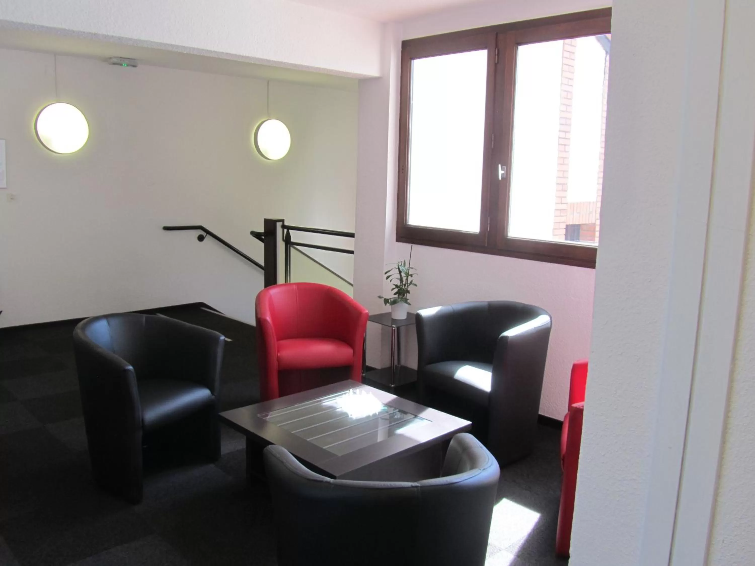 Communal lounge/ TV room in Hôtel Le Saint Joseph