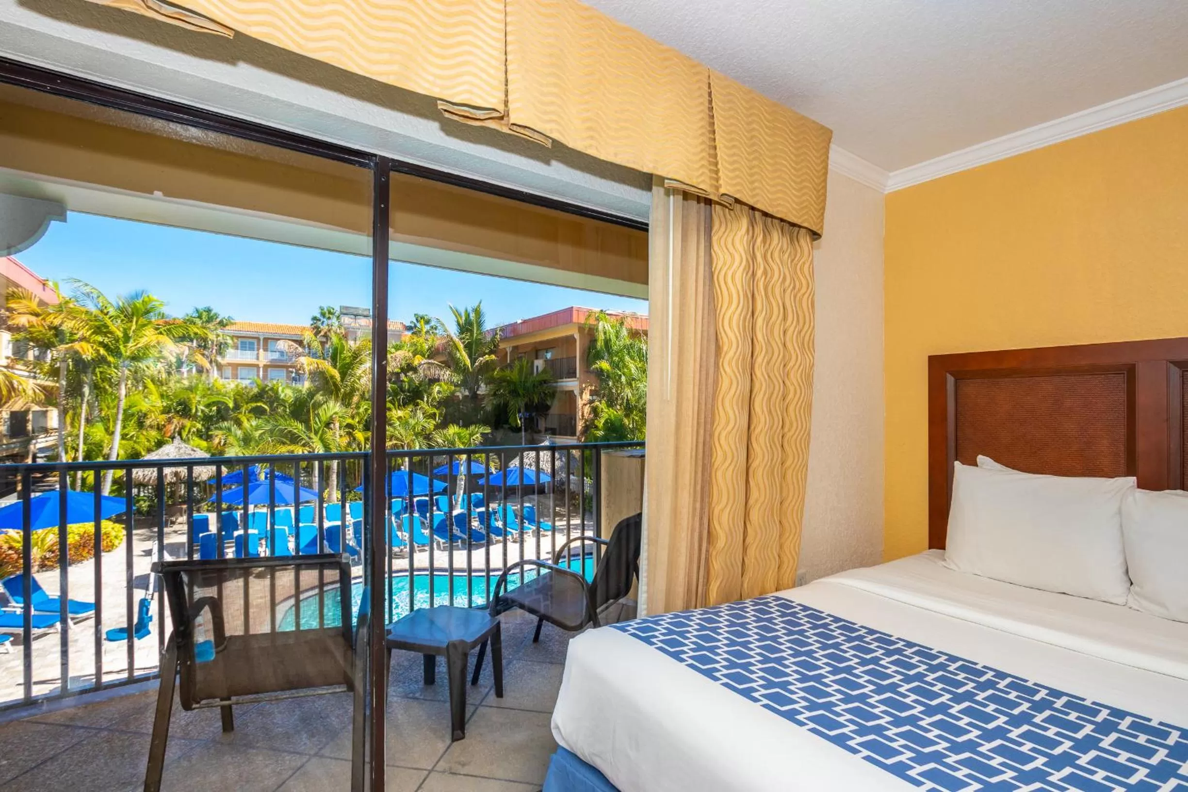 Bed, Pool View in Coconut Cove All Suite Hotel