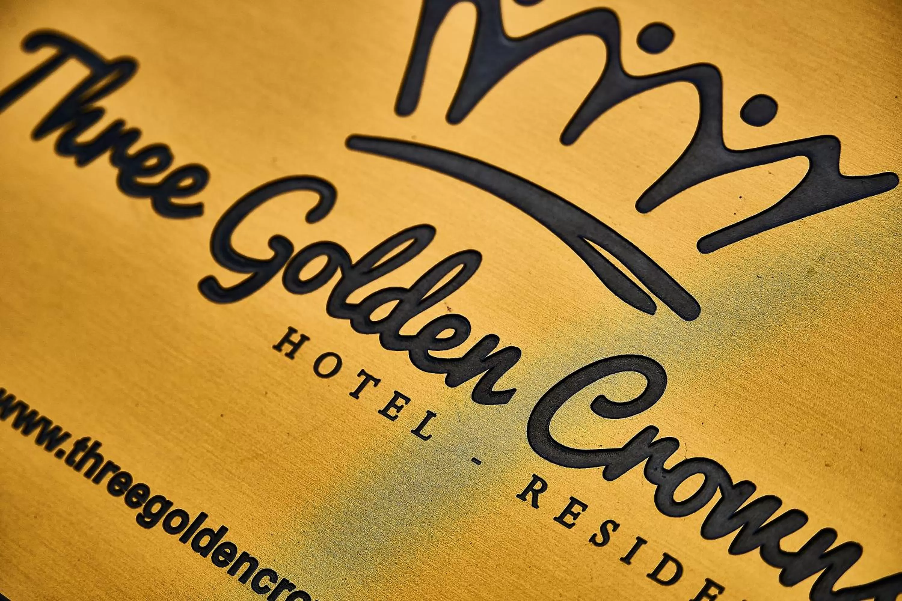 Property logo or sign in Three Golden Crowns Apartments