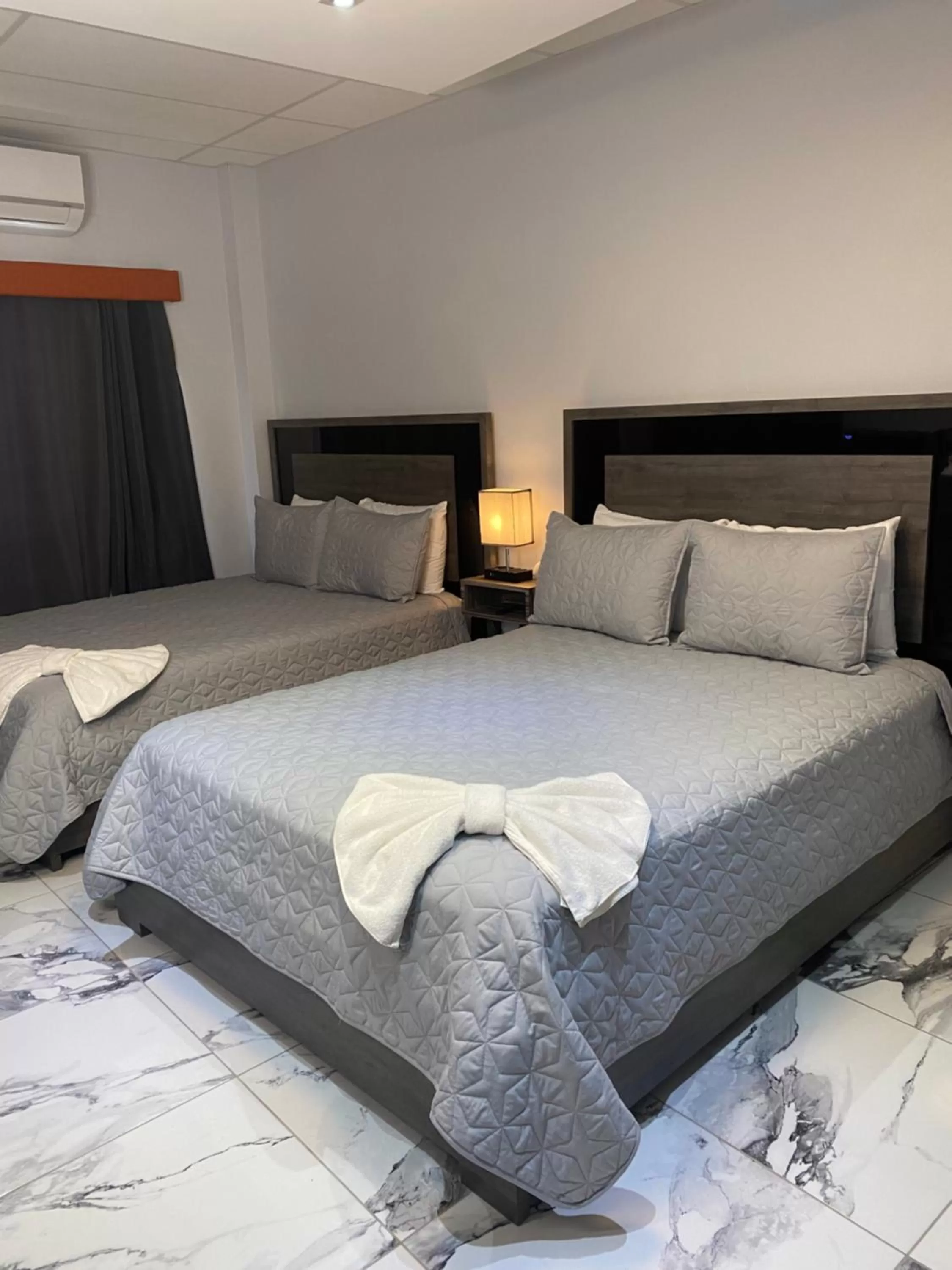 Bed in Itza-Bella Suites