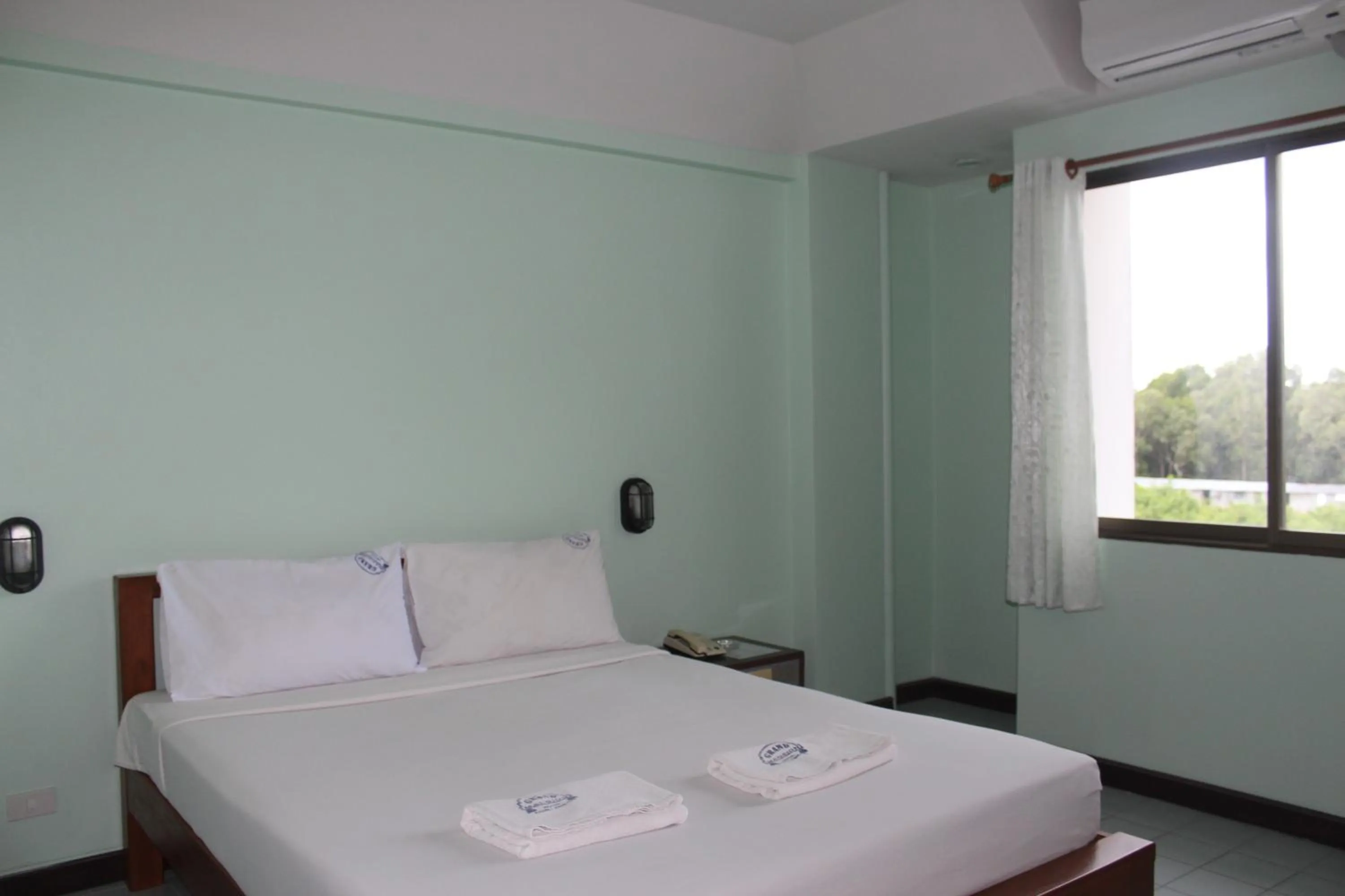 Bed in Grand Mansion Hotel