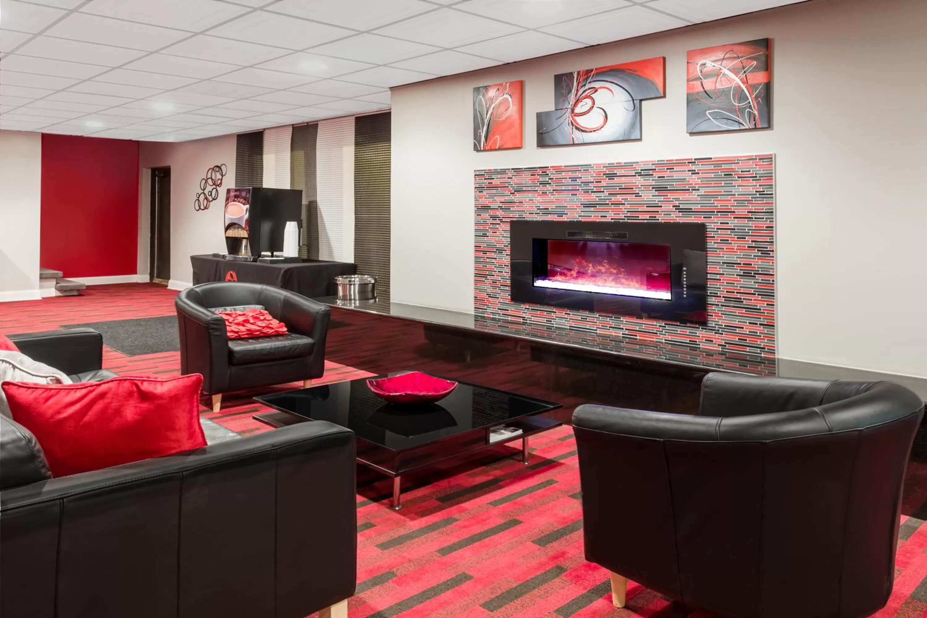 Communal lounge/ TV room in AmericInn by Wyndham Janesville