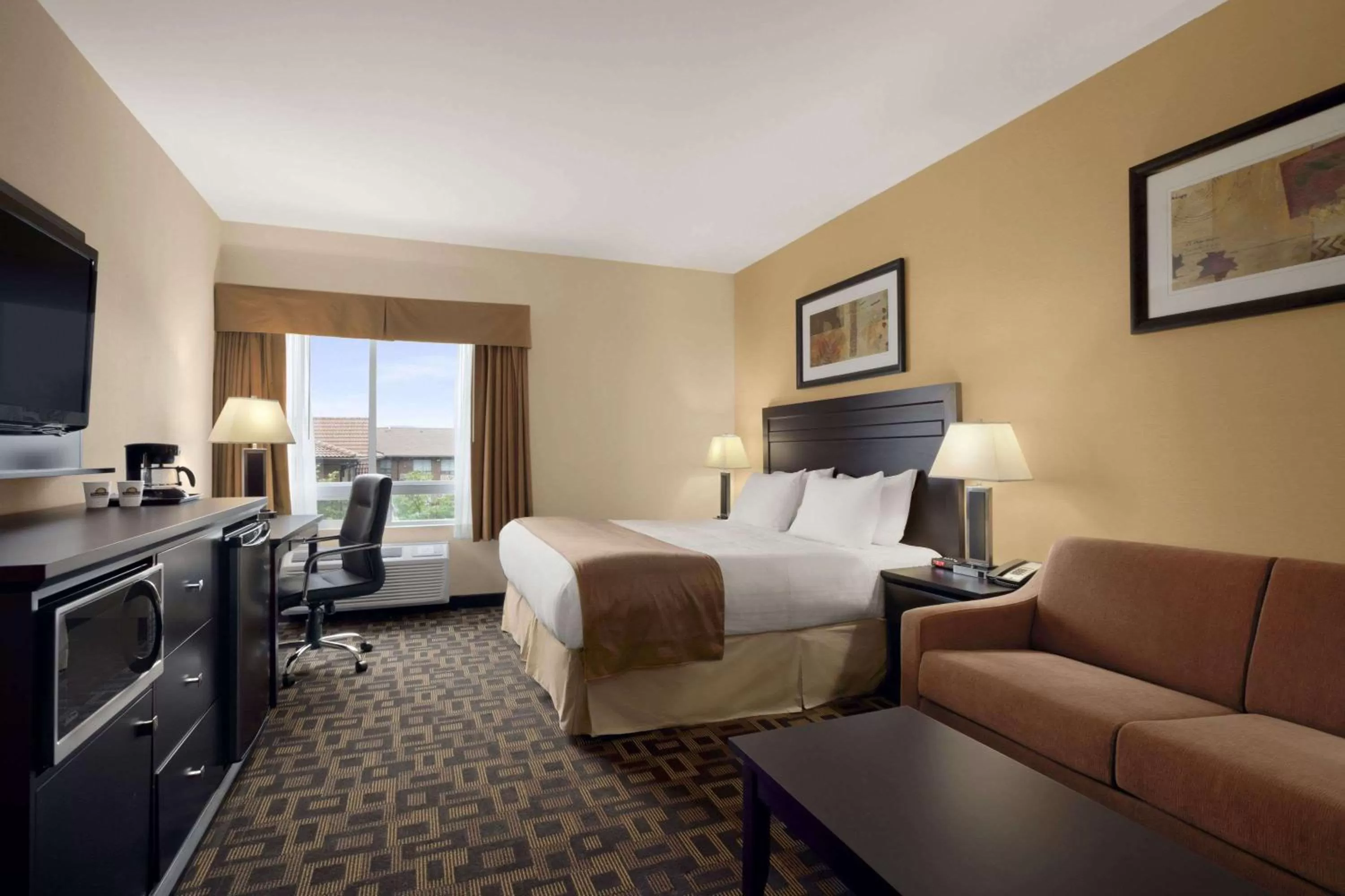 Photo of the whole room, Bed in Days Inn & Suites by Wyndham Winnipeg Airport Manitoba