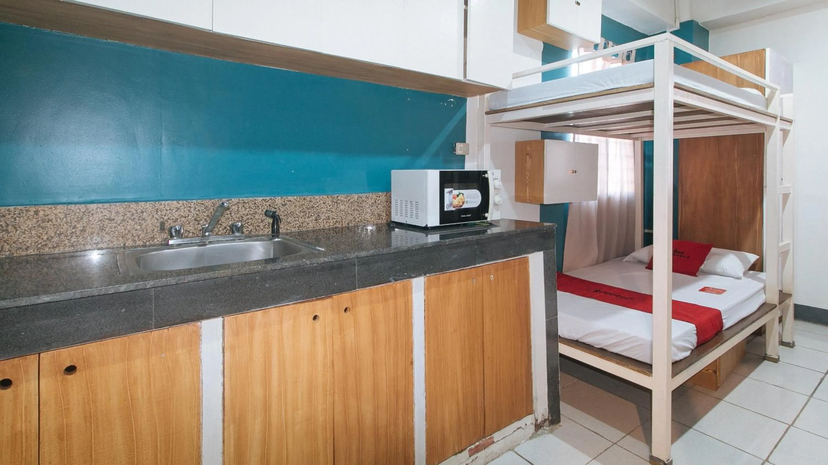 Kitchen or kitchenette, Bed in RedDoorz at Crowne One Condo