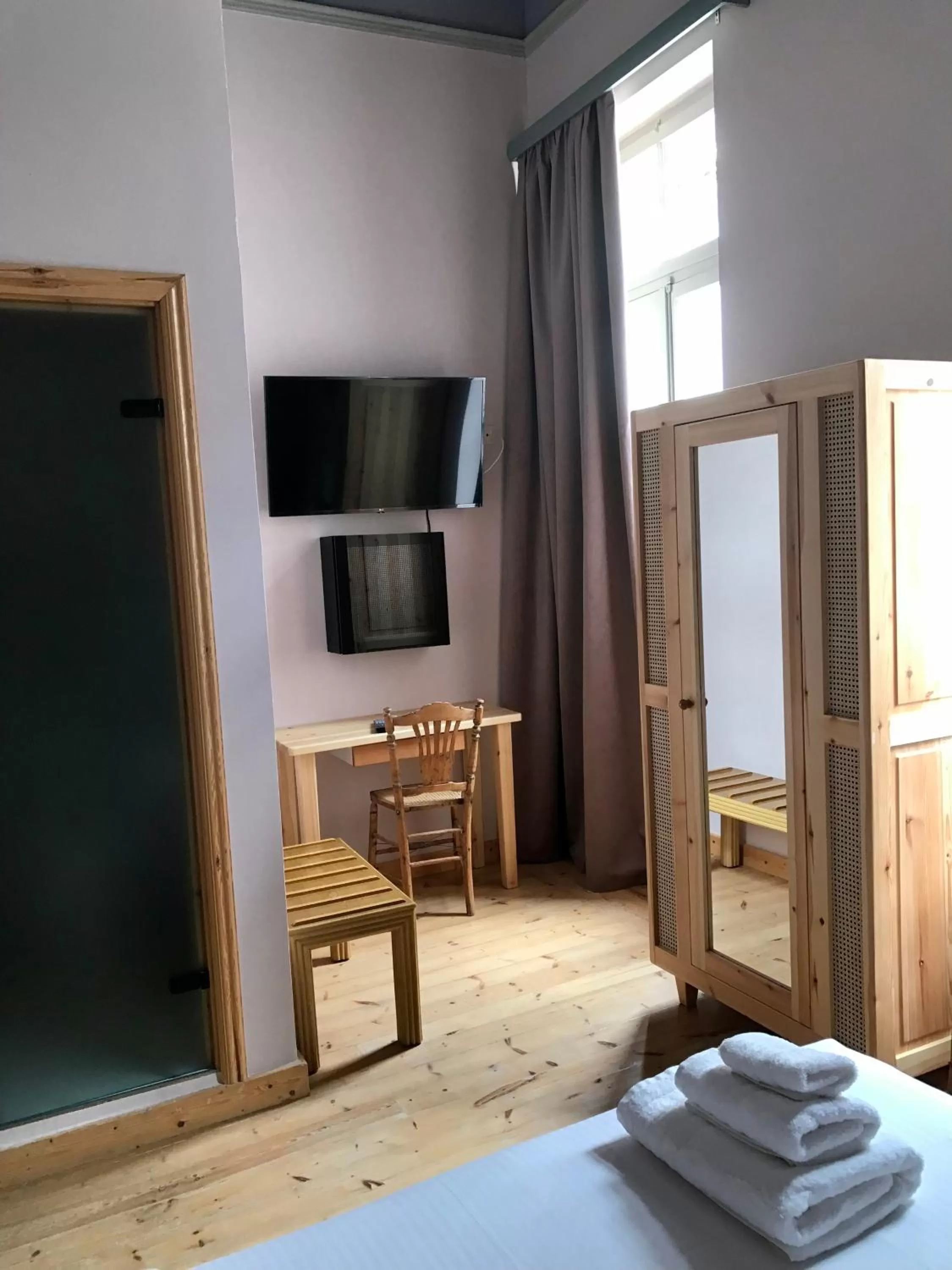 Photo of the whole room, Bed in VASILIKON Hotel 1888 the past is present HISTORICAL PRESERVATION MONUMENT