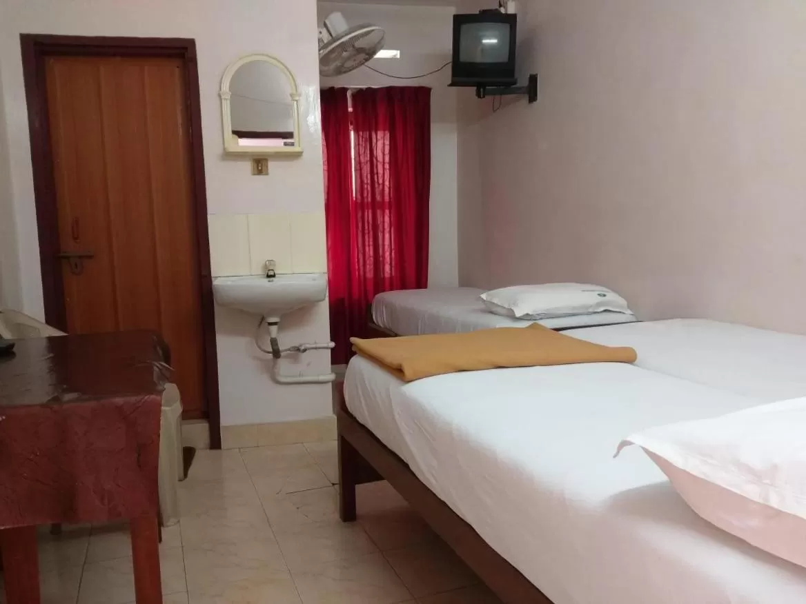 Bed in Anandan Tourist Home