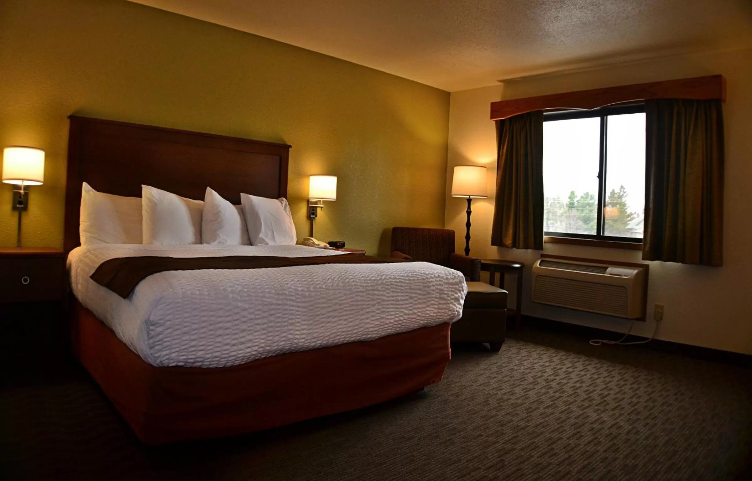 Bed in AmericInn by Wyndham Calumet