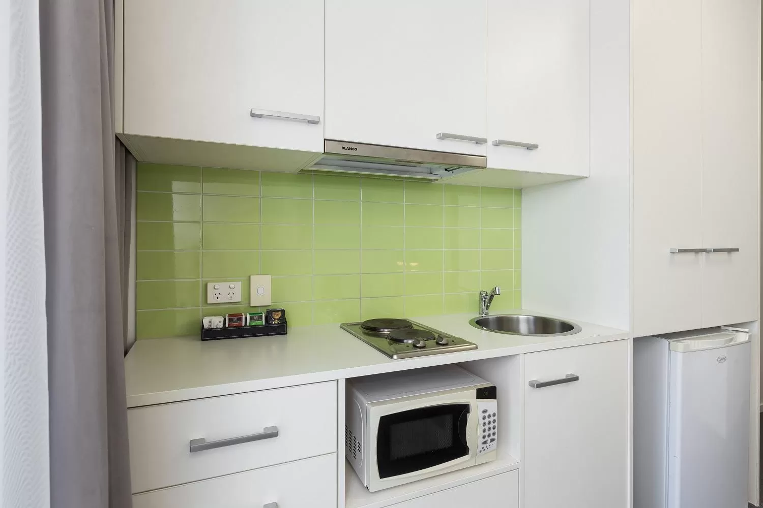 Kitchen or kitchenette in City Edge North Melbourne Apartment Hotel