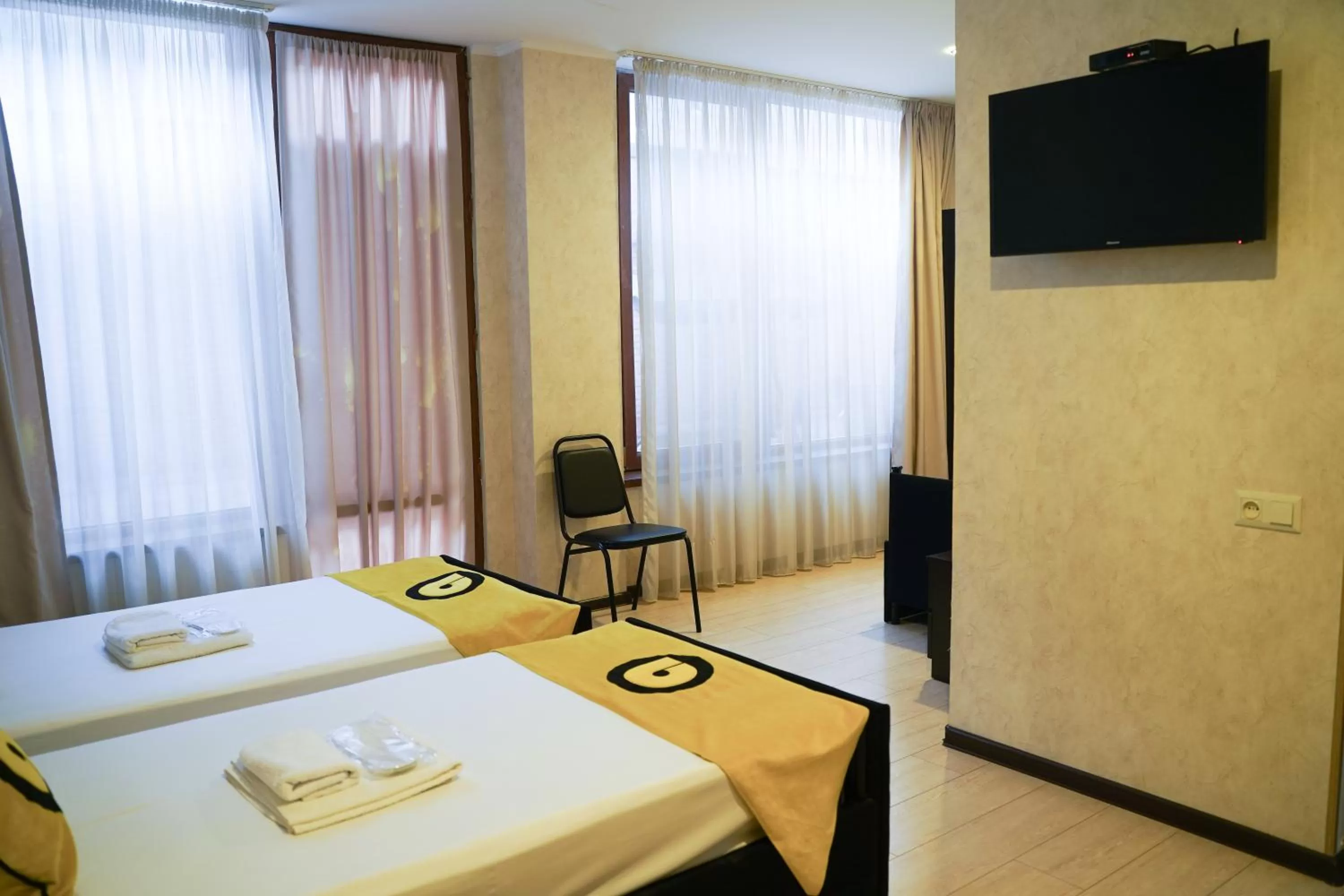 Photo of the whole room, TV/Entertainment Center in Aura Plaza Hotel