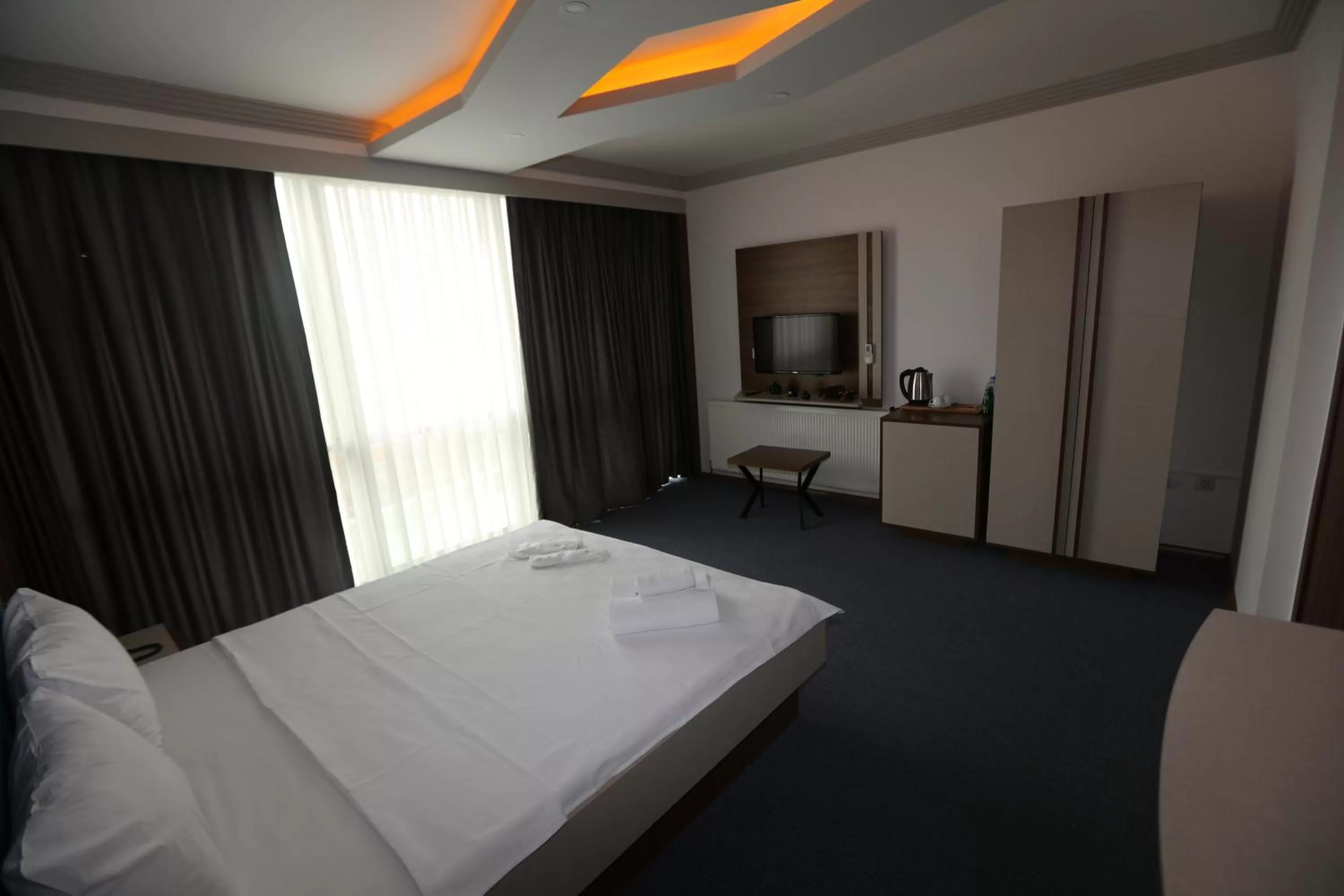 Bed in TEVETOGLU HOTEL