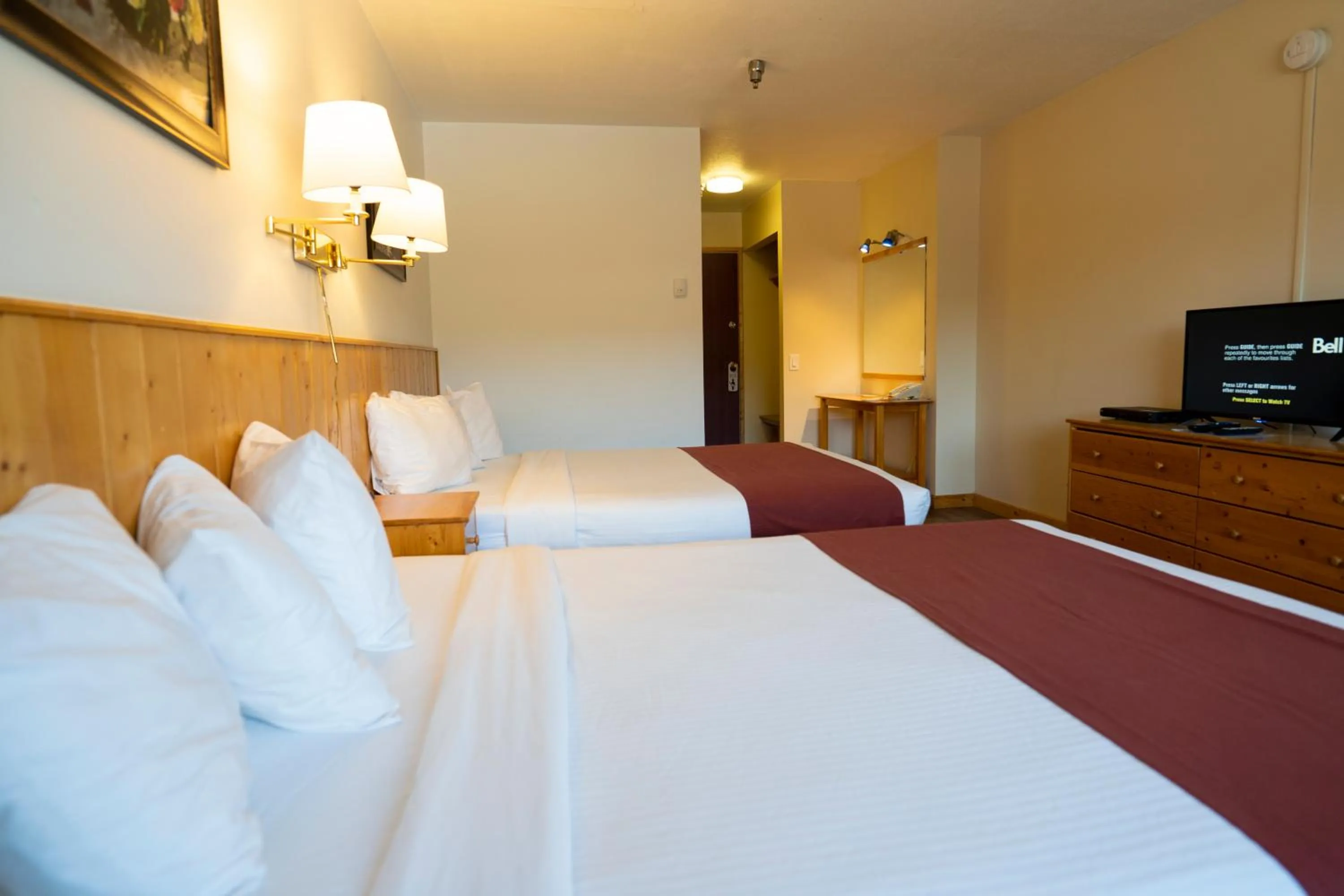Bed in Canadas Best Value Inn- Riverview Hotel