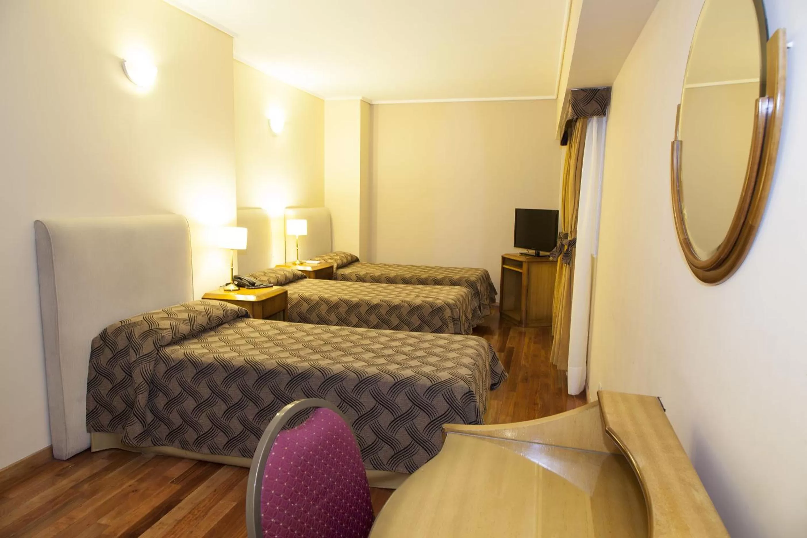 Bed in Tritone Hotel