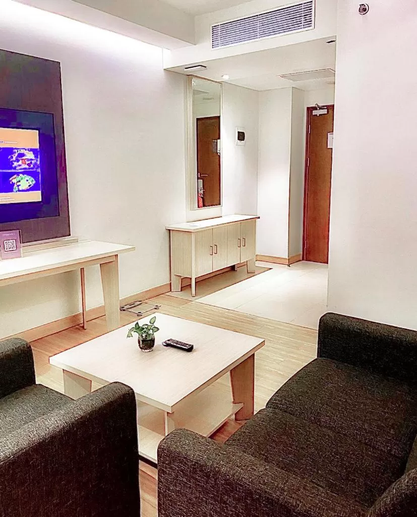 Living room in Harper Palembang by ASTON