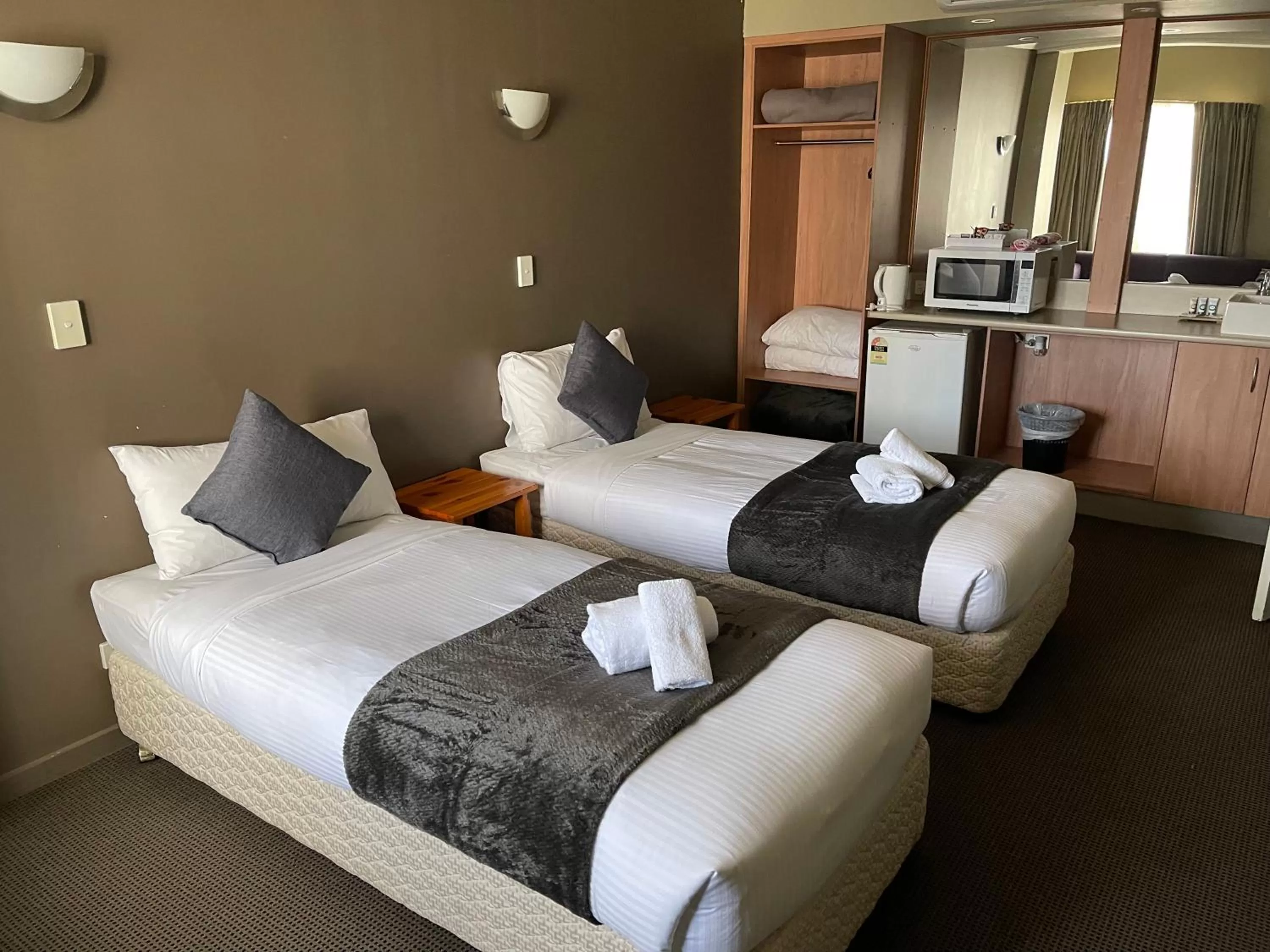 Bed in The Astor Hotel Motel