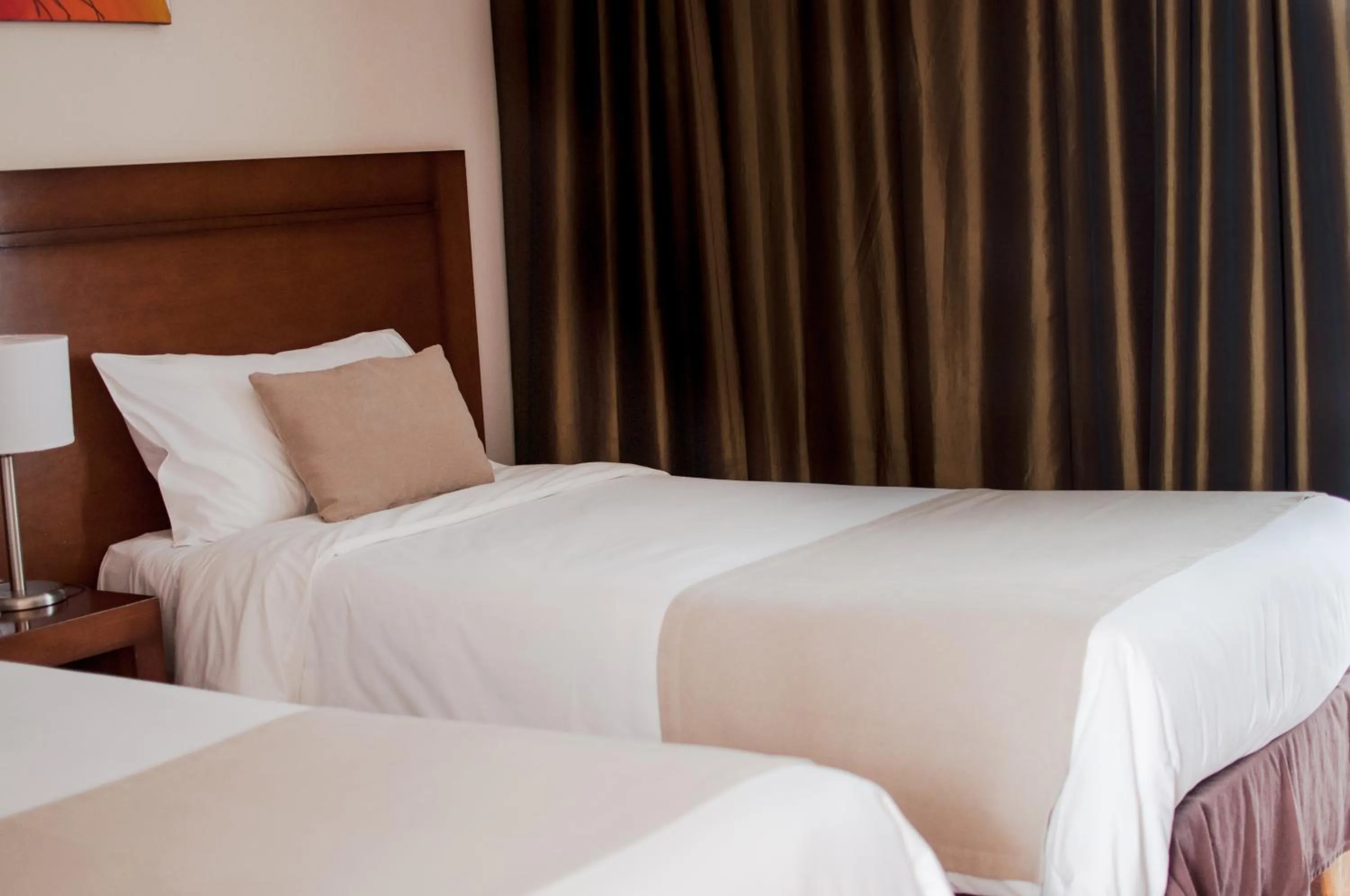 Bed in Herradura Hotel Suites