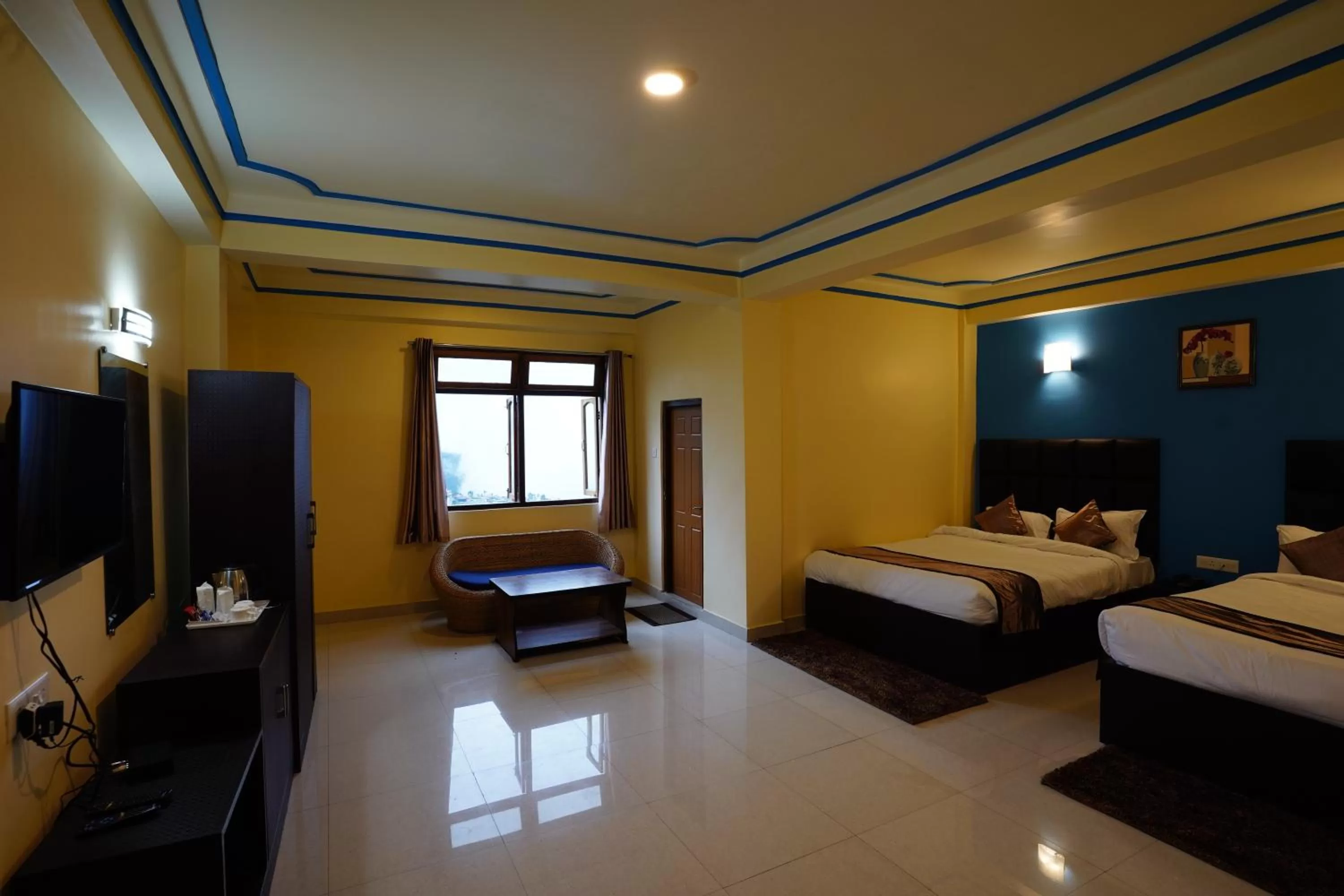 Bed, TV/Entertainment Center in Hotel White Lotus Gangtok