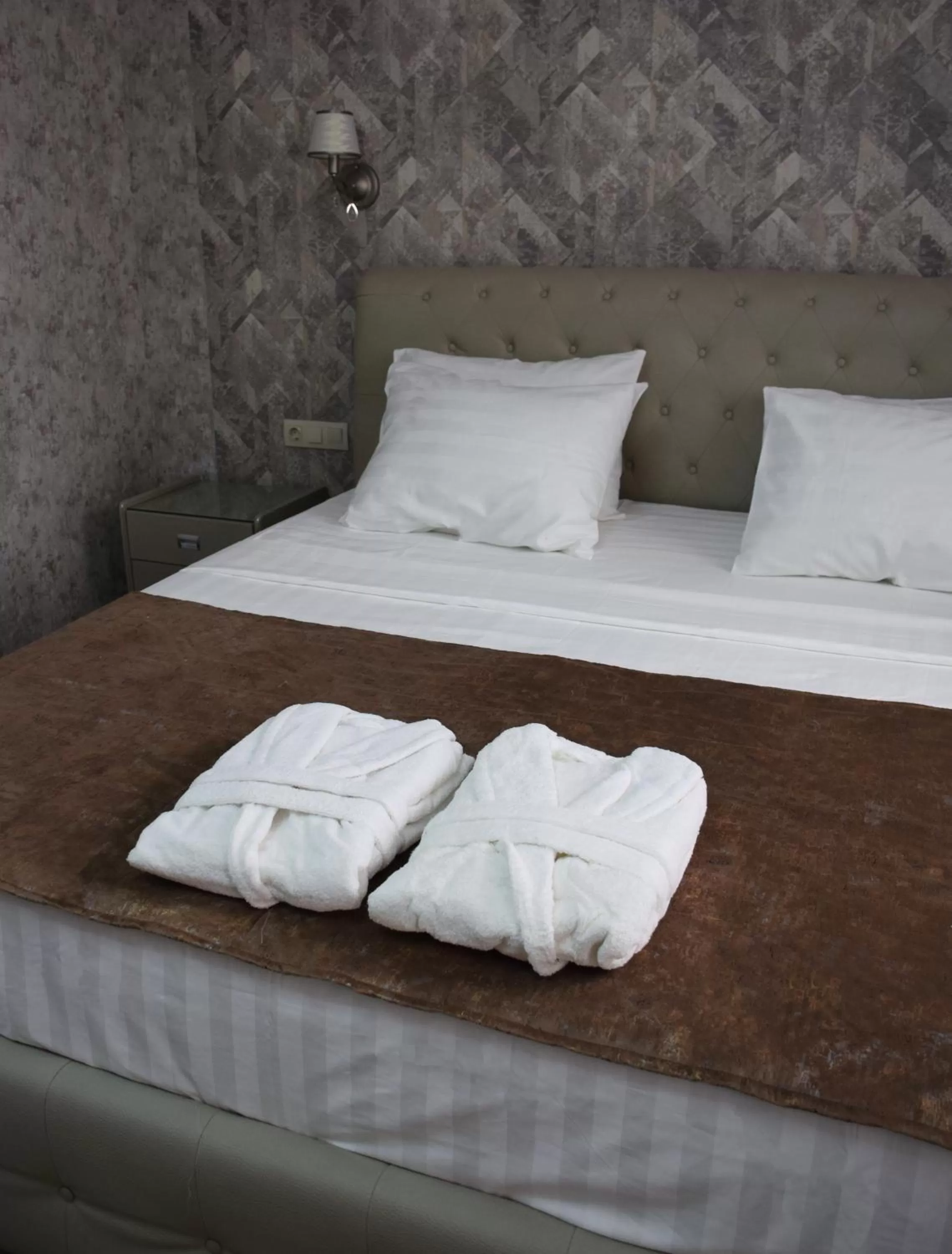 Bed in MirOtel Hotel