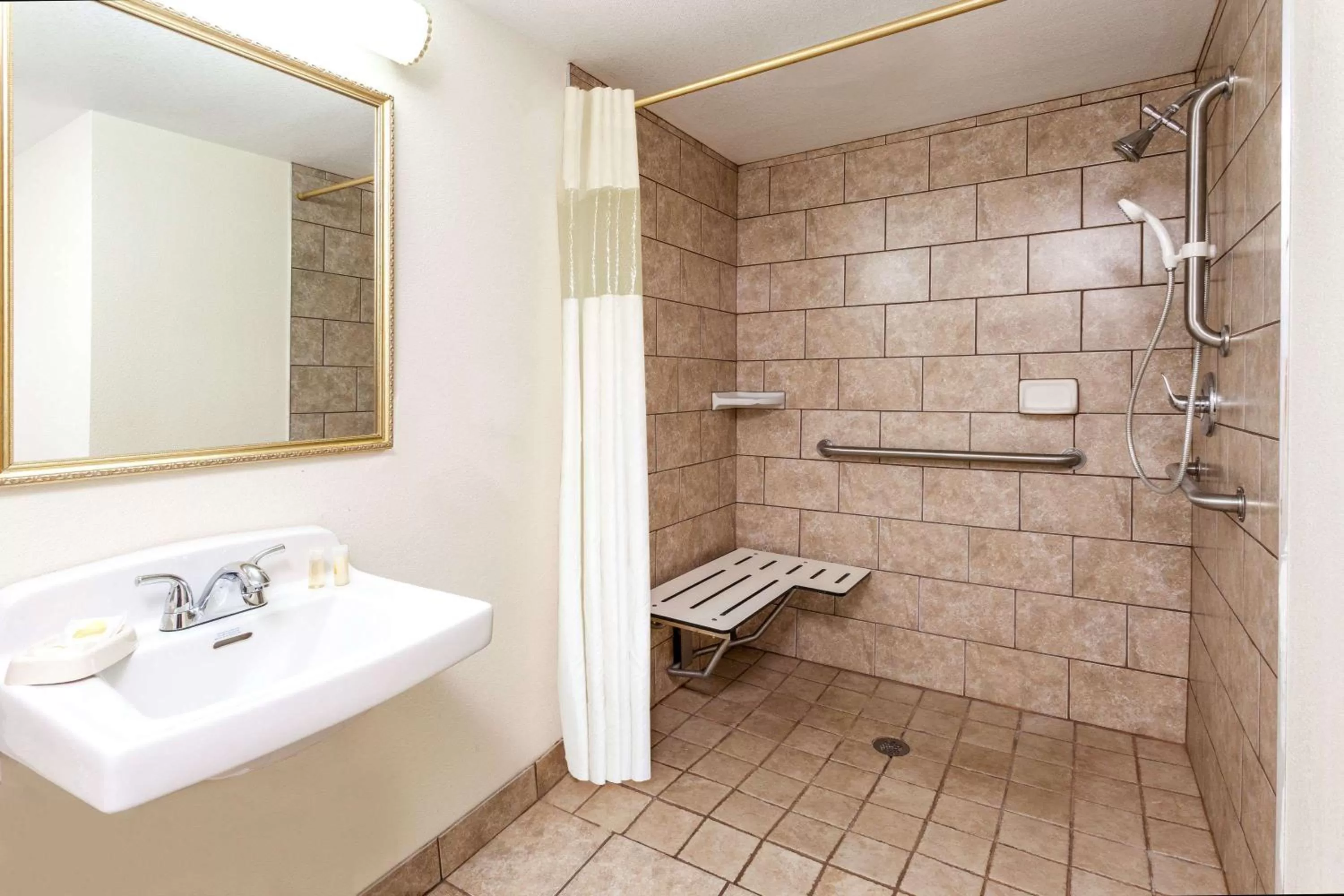 Bathroom in Days Inn & Suites by Wyndham Roseville/Detroit Area