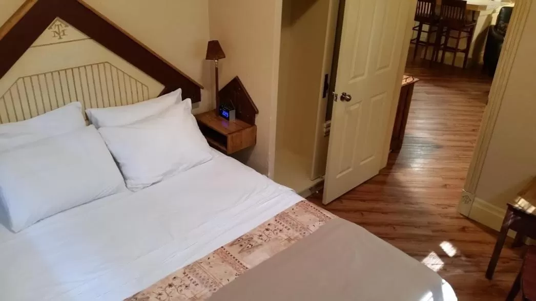 Bed in Third Mission Heritage Suites