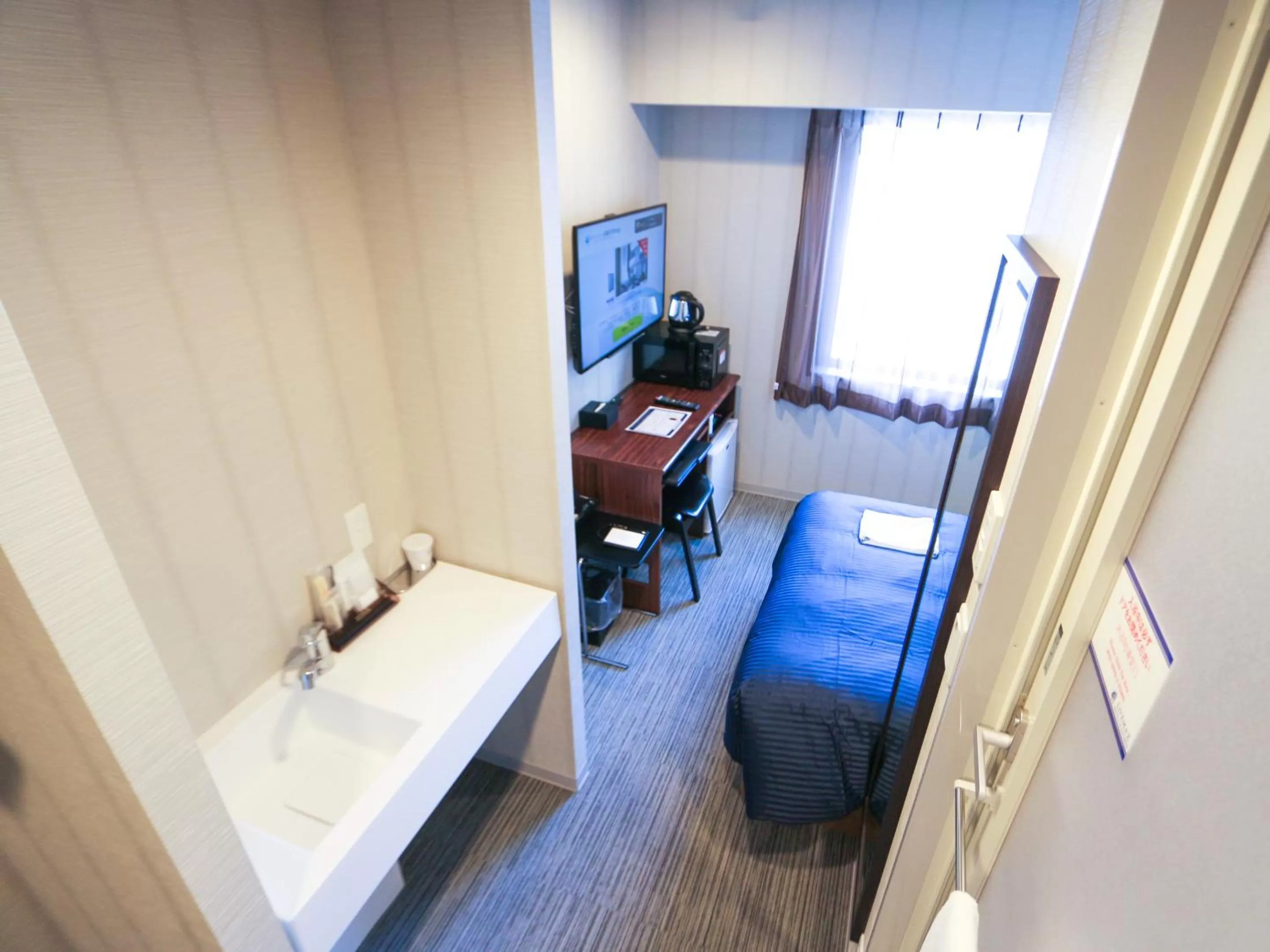 Photo of the whole room, Bed in HOTEL LiVEMAX Sapporo Susukino