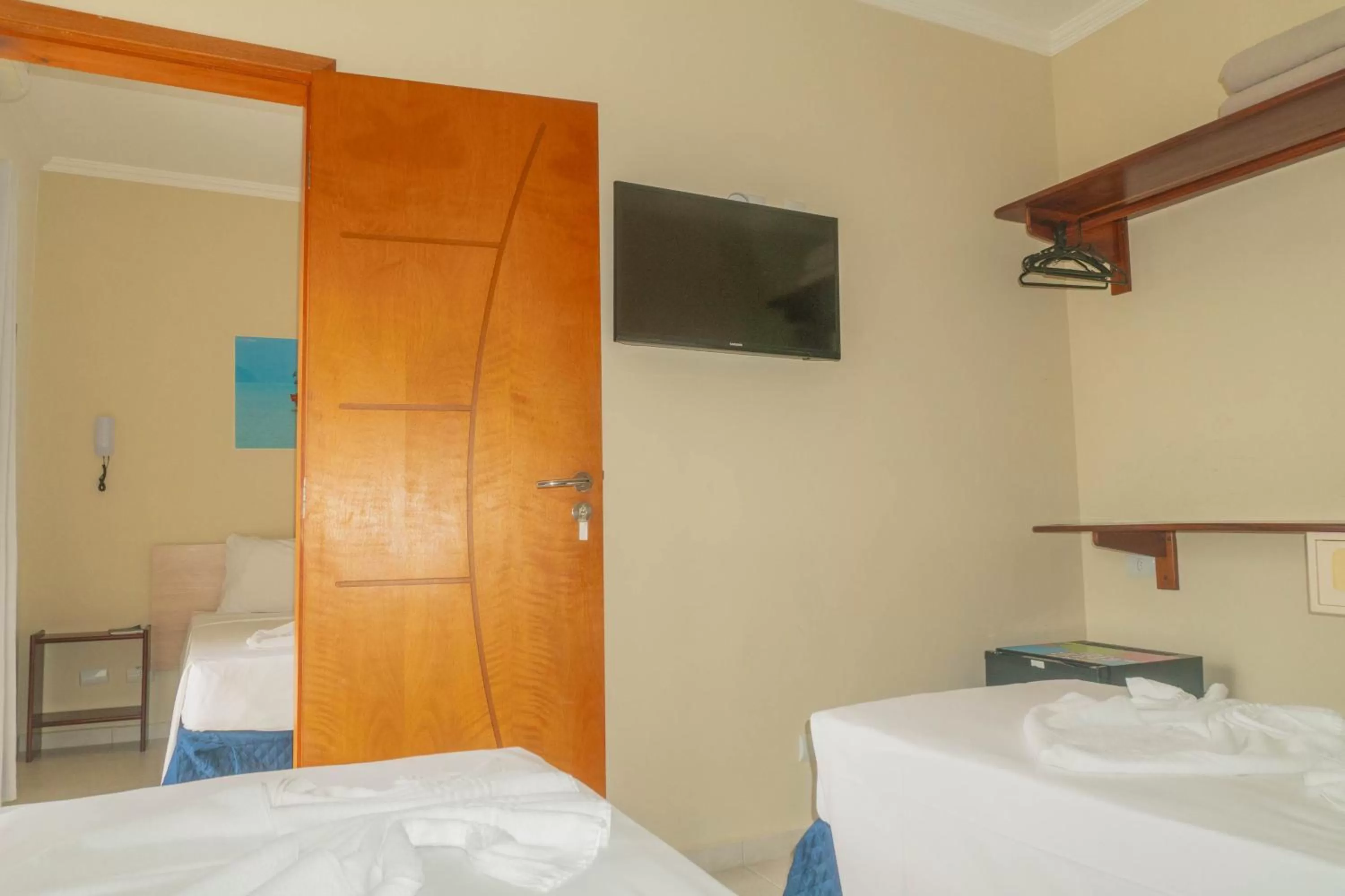 Communal lounge/ TV room, Bed in UPG Hotel